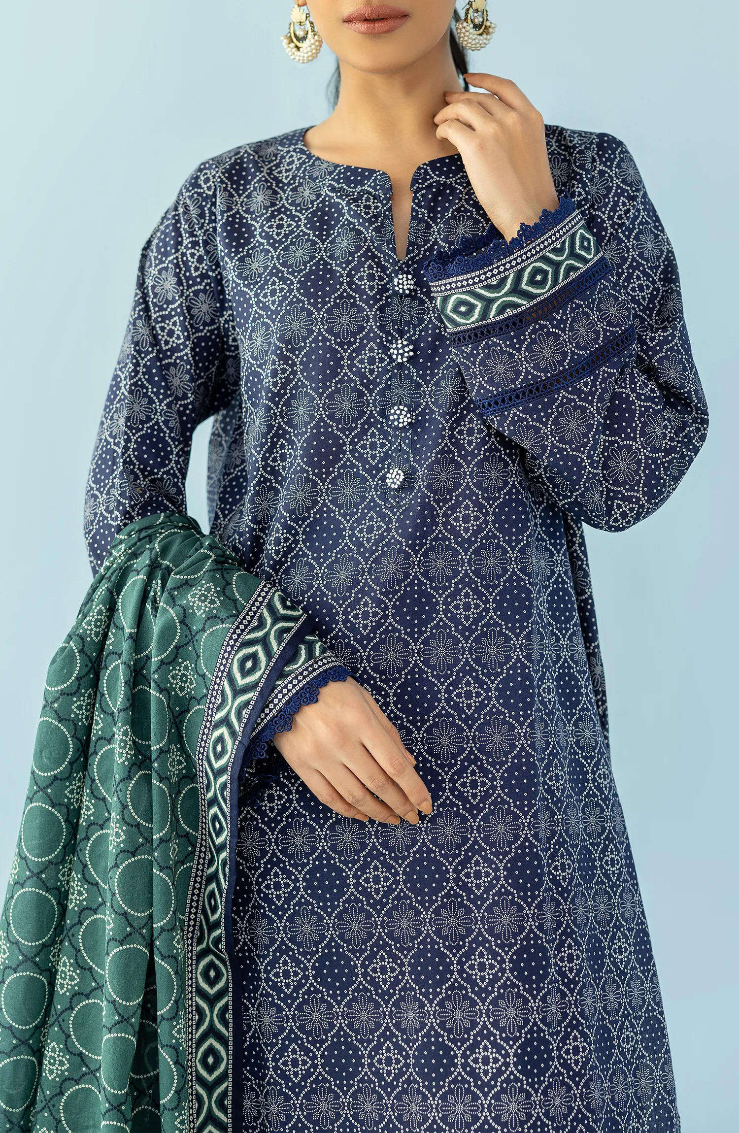 Woman wearing a navy blue patterned kurta with blue pants and a green dupatta on a blue trouser. Unstitched Printed Lawn Shirt Dupatta & Pant - 3 Piece Suits - OTL-20125