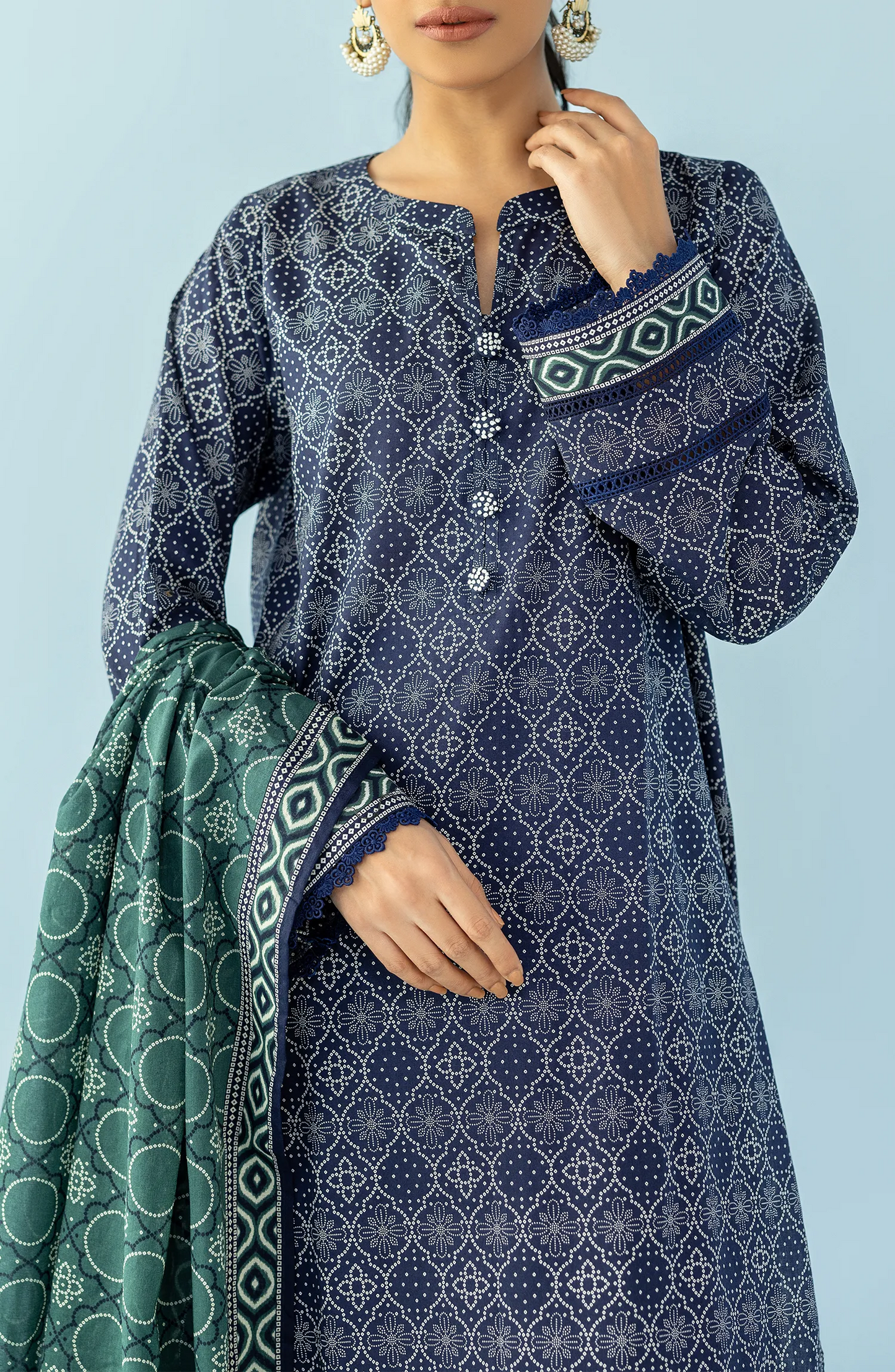 Woman wearing a navy blue patterned kurta with blue pants and a green dupatta on a blue trouser. Unstitched Printed Lawn Shirt Dupatta & Pant - 3 Piece Suits - OTL-20125