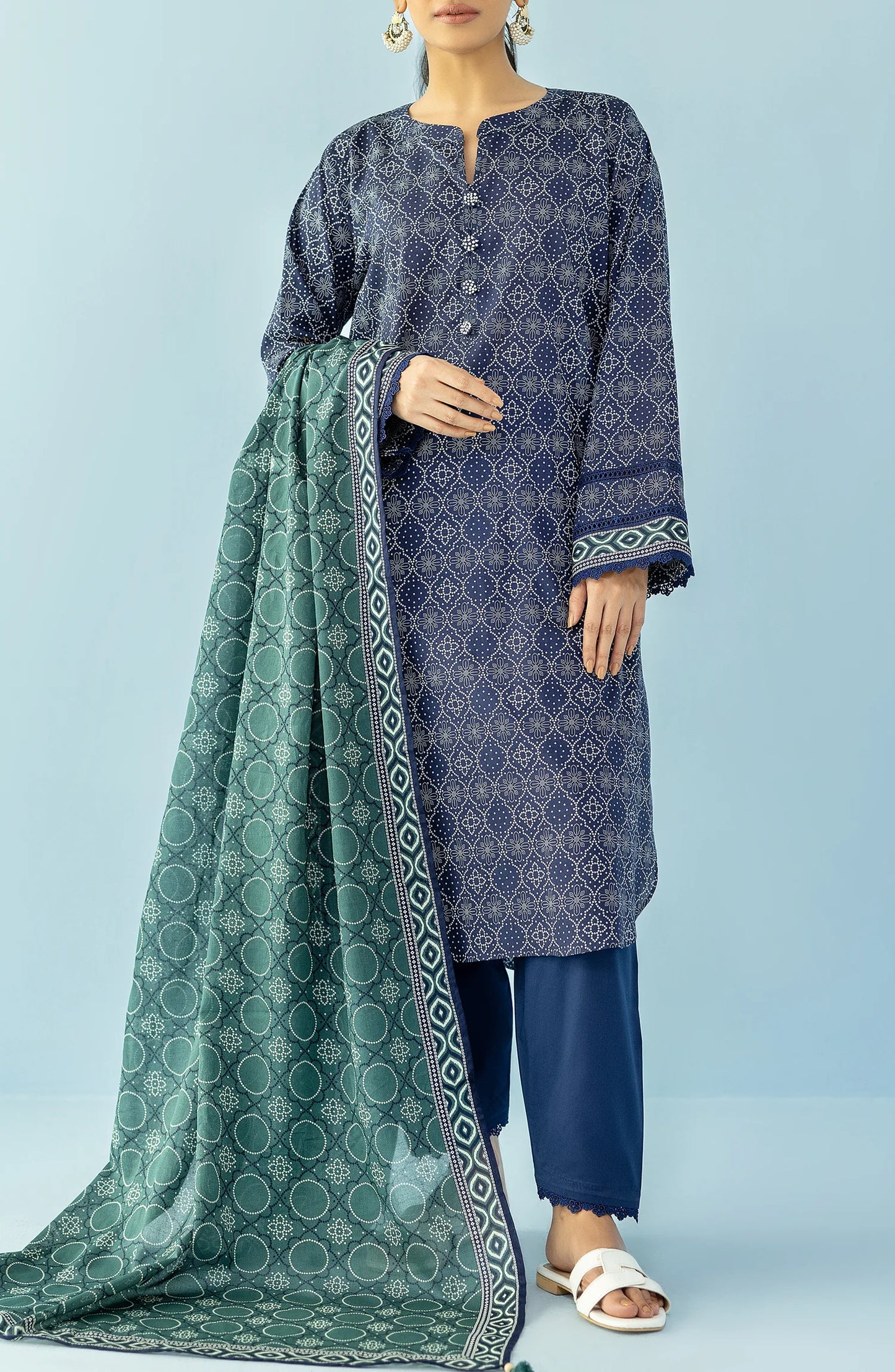 Woman wearing a navy blue patterned kurta with blue pants and a green dupatta on a blue trouser. Unstitched Printed Lawn Shirt Dupatta & Pant - 3 Piece Suits - OTL-20125