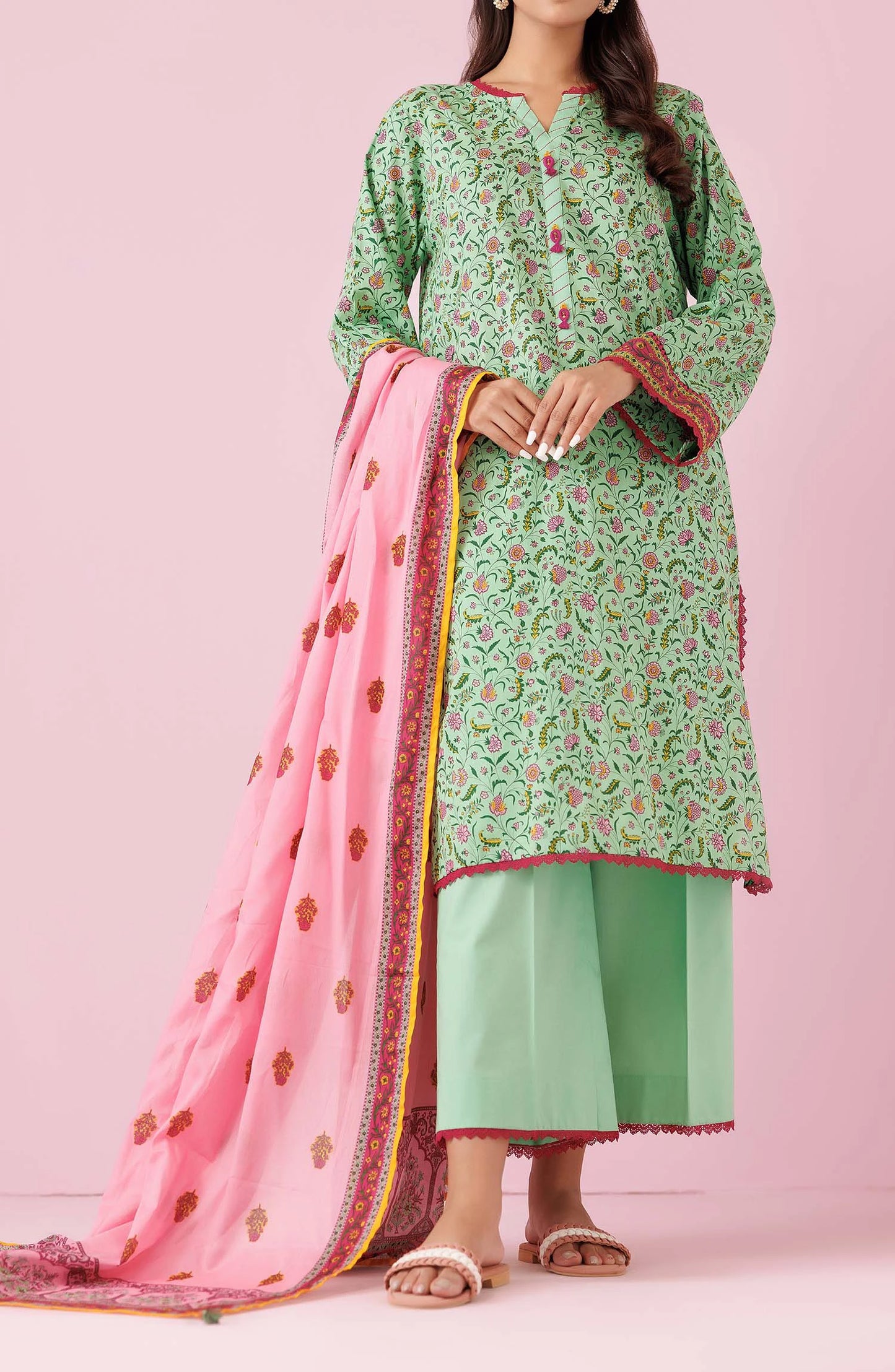 Woman wearing a green floral kurta with light green pants and a pink dupatta on a dyed trouser. Unstitched Printed Lawn Shirt Dupatta & Pant - 3 Piece Suits - OTL-20135