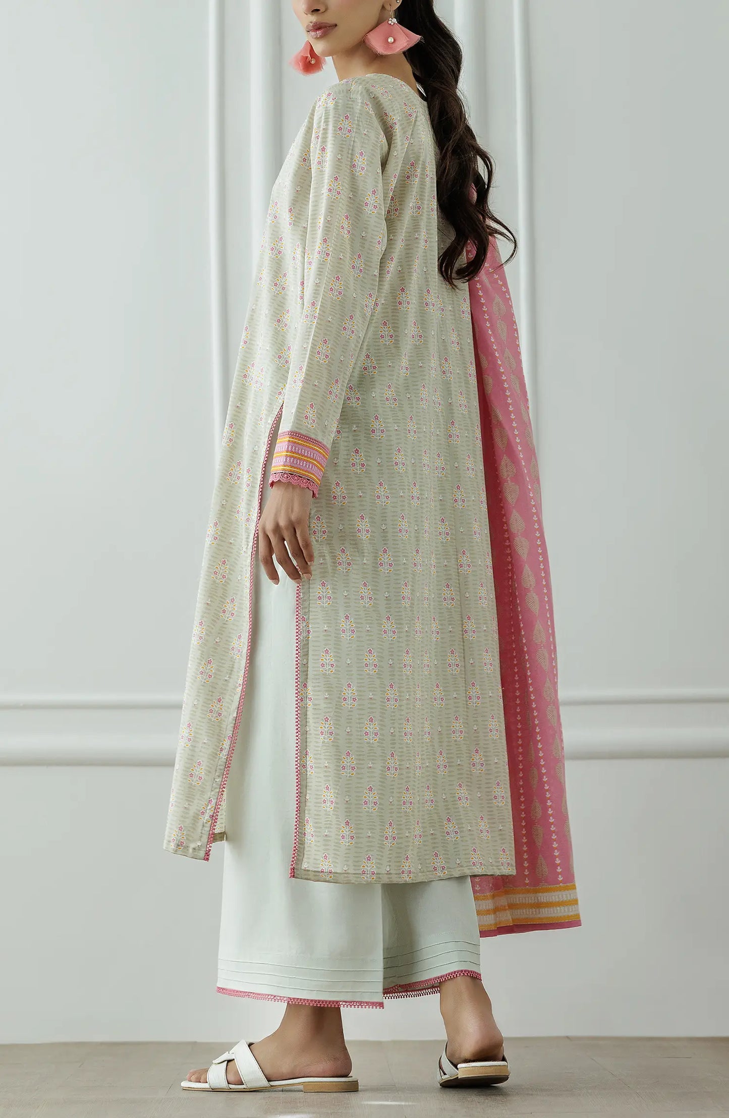 Stitched Printed Lawn Shirt Dupatta & Pant - 3 Piece - OTL-25-019. Woman wearing a traditional outfit with a white and pink patterned dress against a plain background