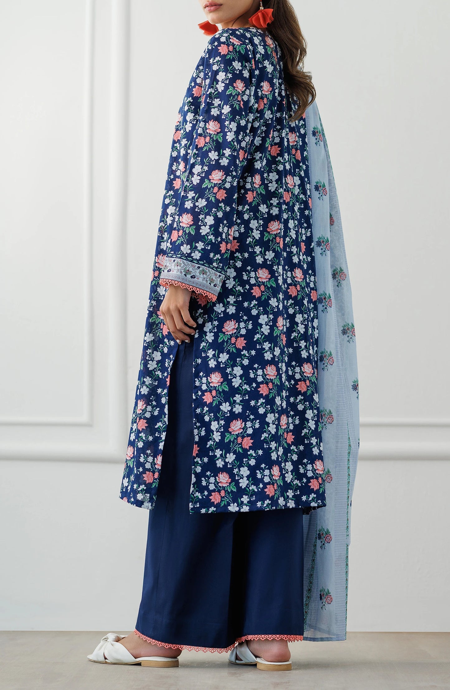 Woman wearing a blue floral kurta with matching pants and a light blue dupatta. Stitched Printed Lawn Shirt Dupatta & Pant - 3 Piece Suits - OTL-25-028