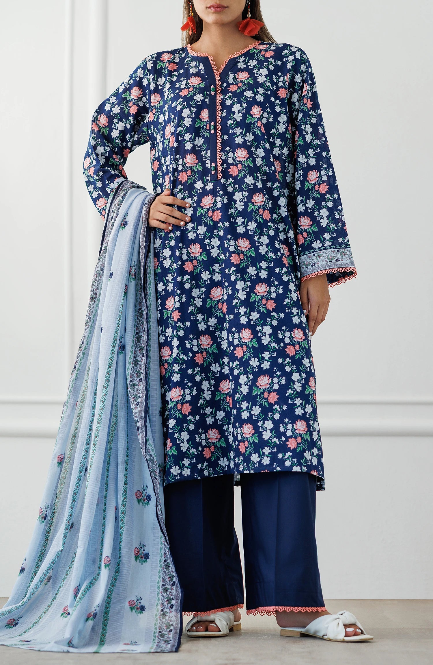 Woman wearing a blue floral kurta with matching pants and a light blue dupatta. Stitched Printed Lawn Shirt Dupatta & Pant - 3 Piece Suits - OTL-25-028