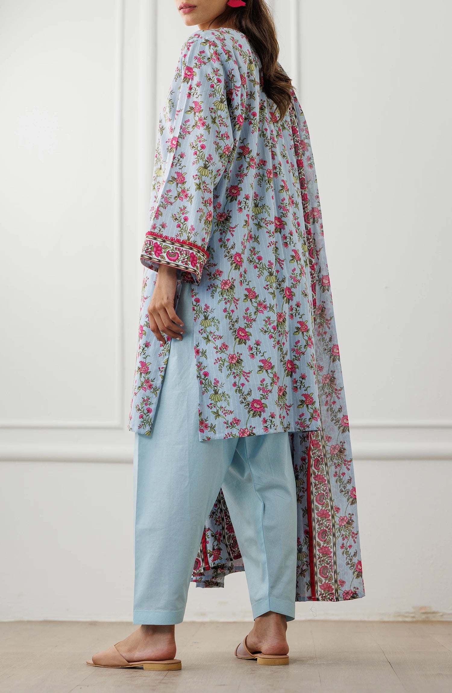 Woman wearing a floral dress with a matching dupatta against a plain traditional shalwar. Unstitched Printed Lawn Shirt Dupatta & Pant - 3 Piece Suits - OTL-25-029