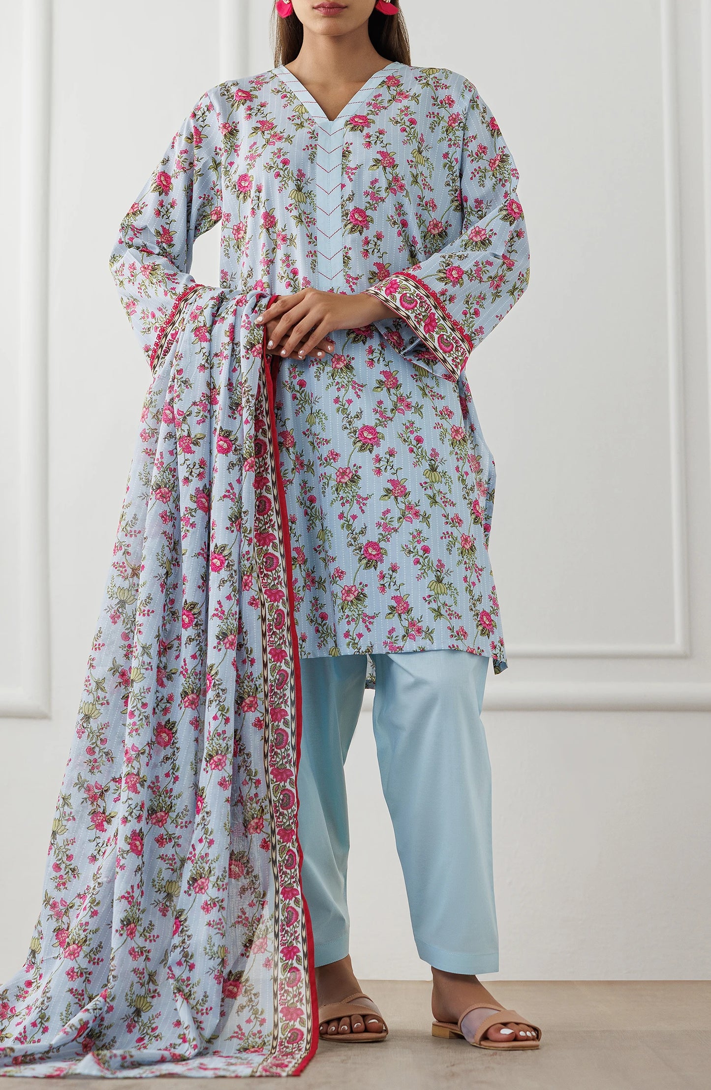 Woman wearing a floral dress with a matching dupatta against a plain traditional shalwar. Unstitched Printed Lawn Shirt Dupatta & Pant - 3 Piece Suits - OTL-25-029