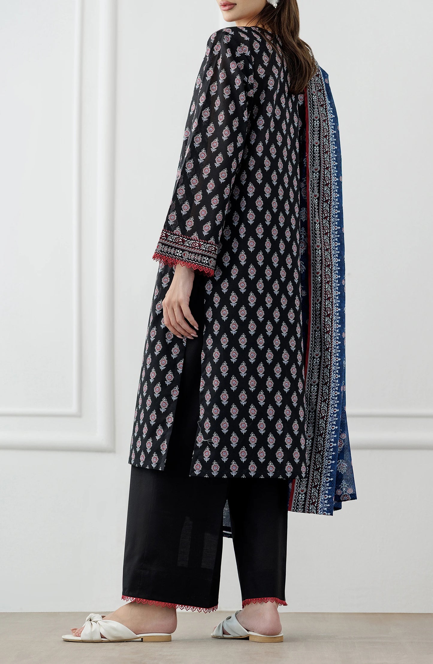 Woman wearing a black and red patterned kurta with a blue dupatta against a plain trouser. Stitched Printed Lawn Shirt Dupatta & Pant - 3 Piece Suits - OTL-25-048