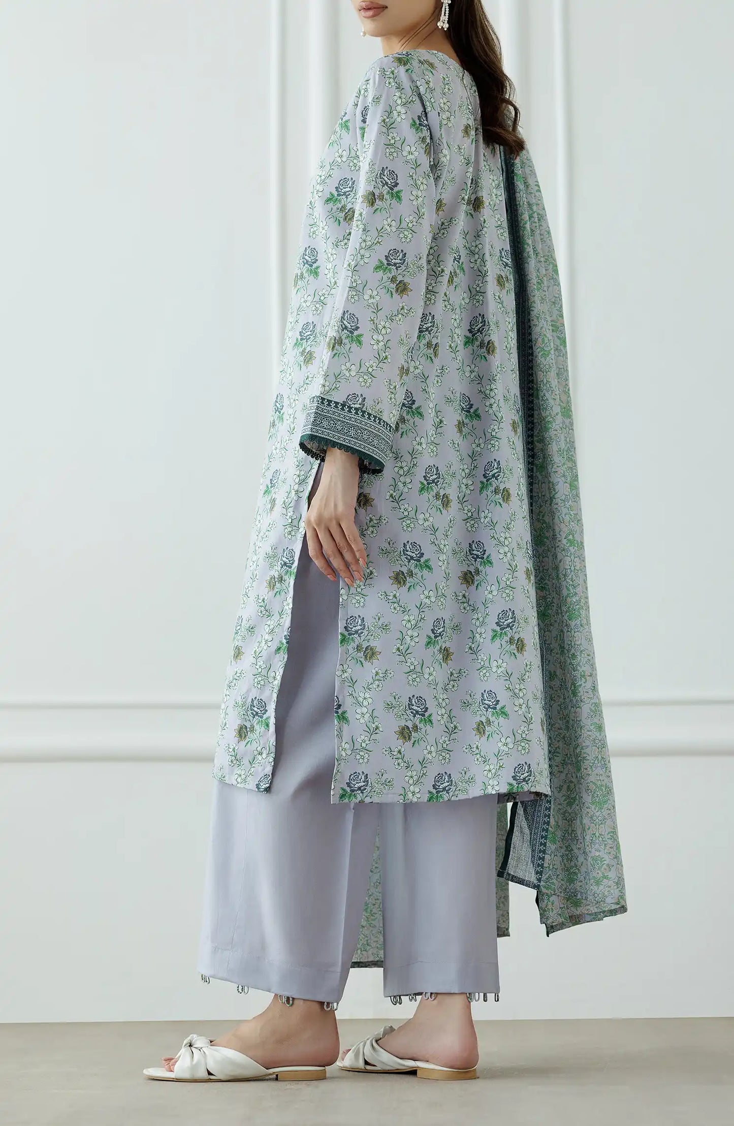 Woman wearing a floral kurta with a matching dupatta against a plain trouser. Stitched Printed Lawn Shirt Dupatta & Pant - 3 Piece Suits - OTL-25-059