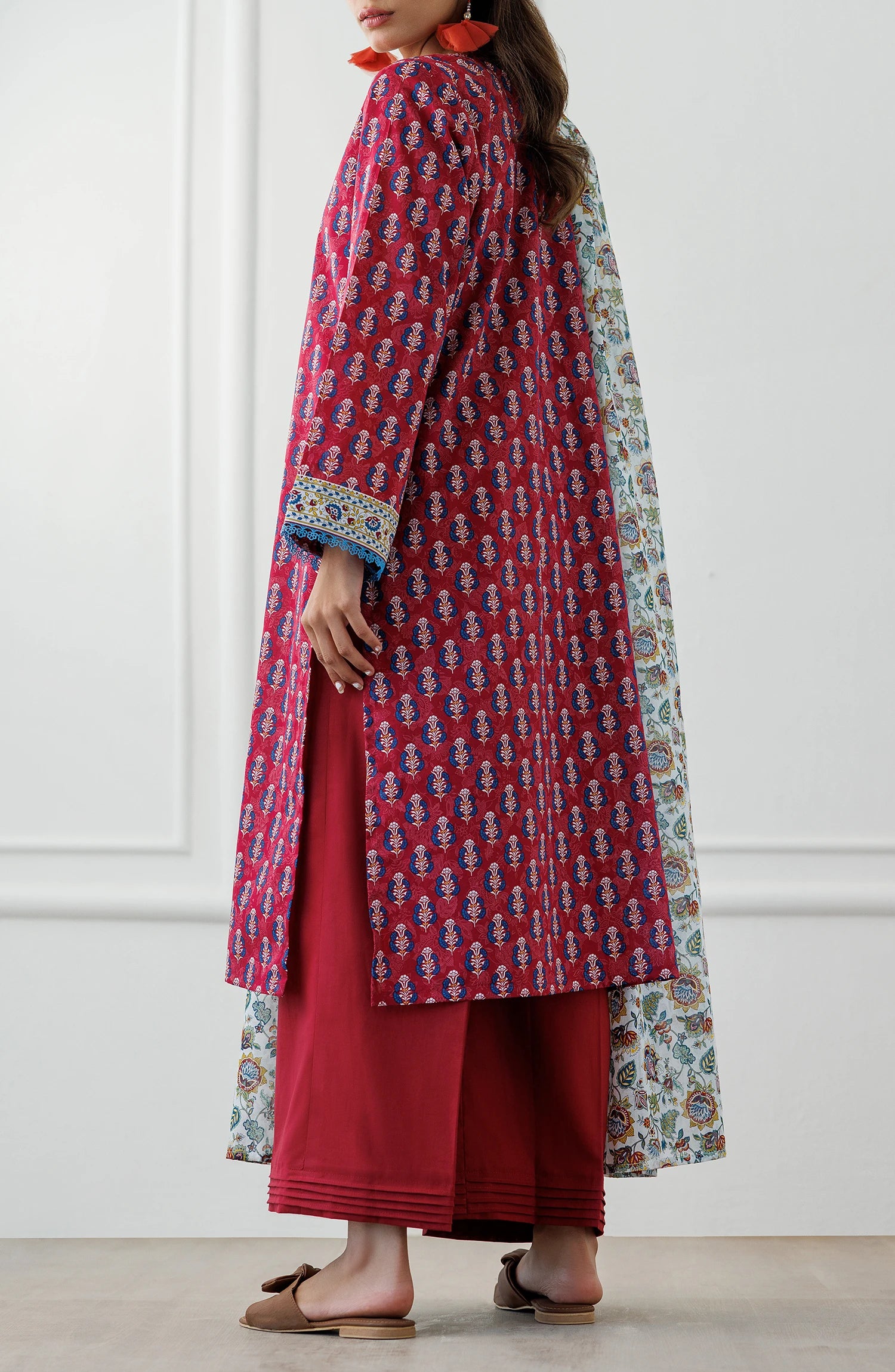 Woman wearing a red patterned kurta with a floral dupatta against a plain dyed trouser. Unstitched Printed Lawn Shirt Dupatta & Pant - 3 Piece Suits - OTL-25-063