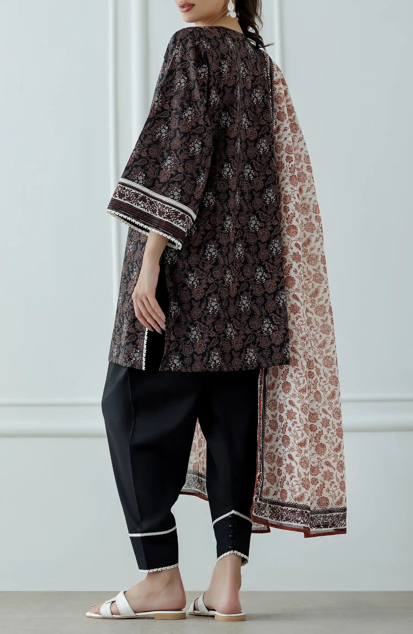 Woman wearing a patterned outfit with a long scarf against a dyed shalwar. Stitched Printed Lawn Shirt Dupatta & Pant - 3 Piece Suits - OTL-25-317