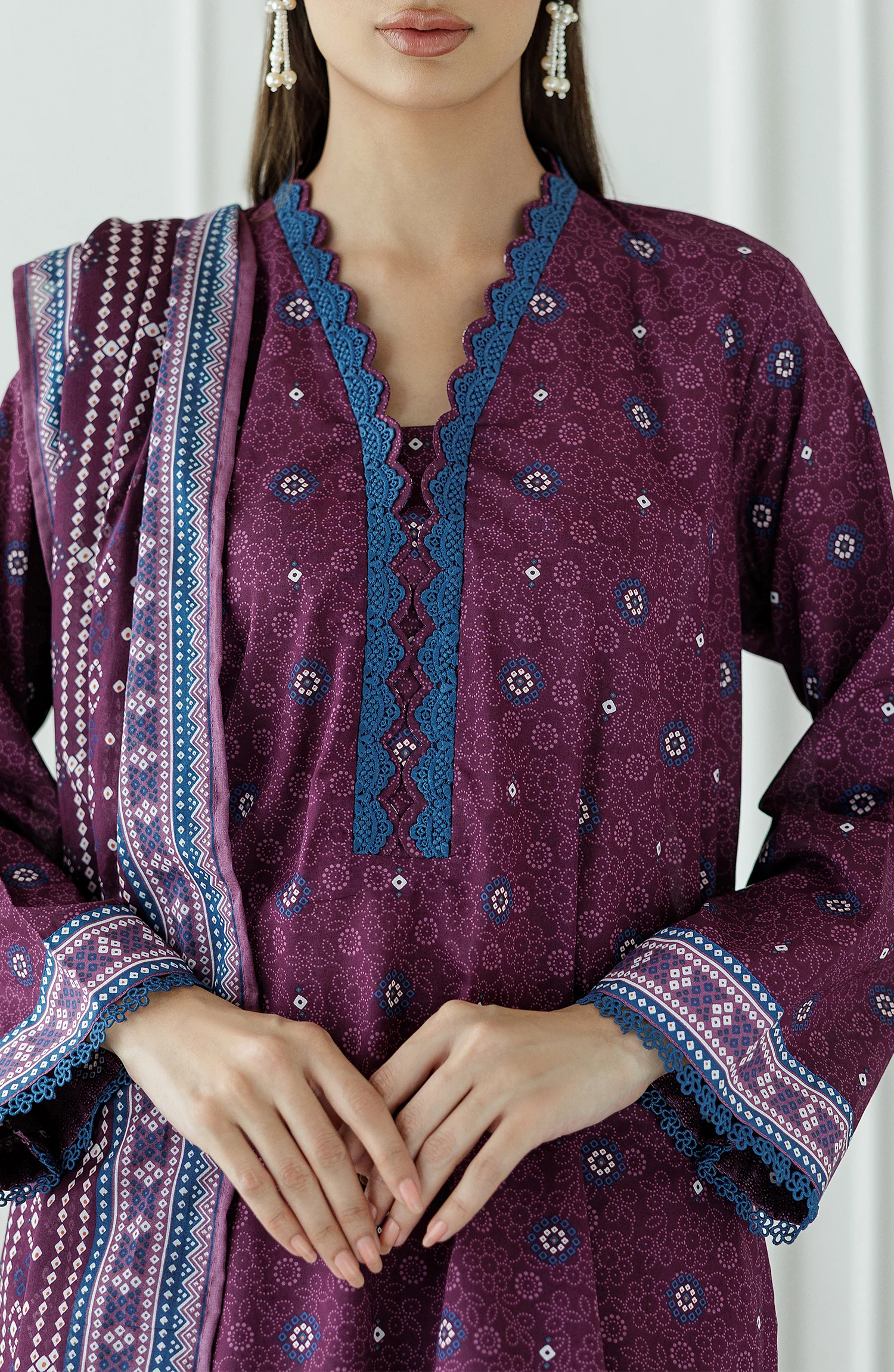 Woman wearing a purple traditional outfit with a matching dupatta against a dyed Trouser. Stitched Printed Lawn Shirt Dupatta & Pant - 3 Piece Suits - OTL-25-325