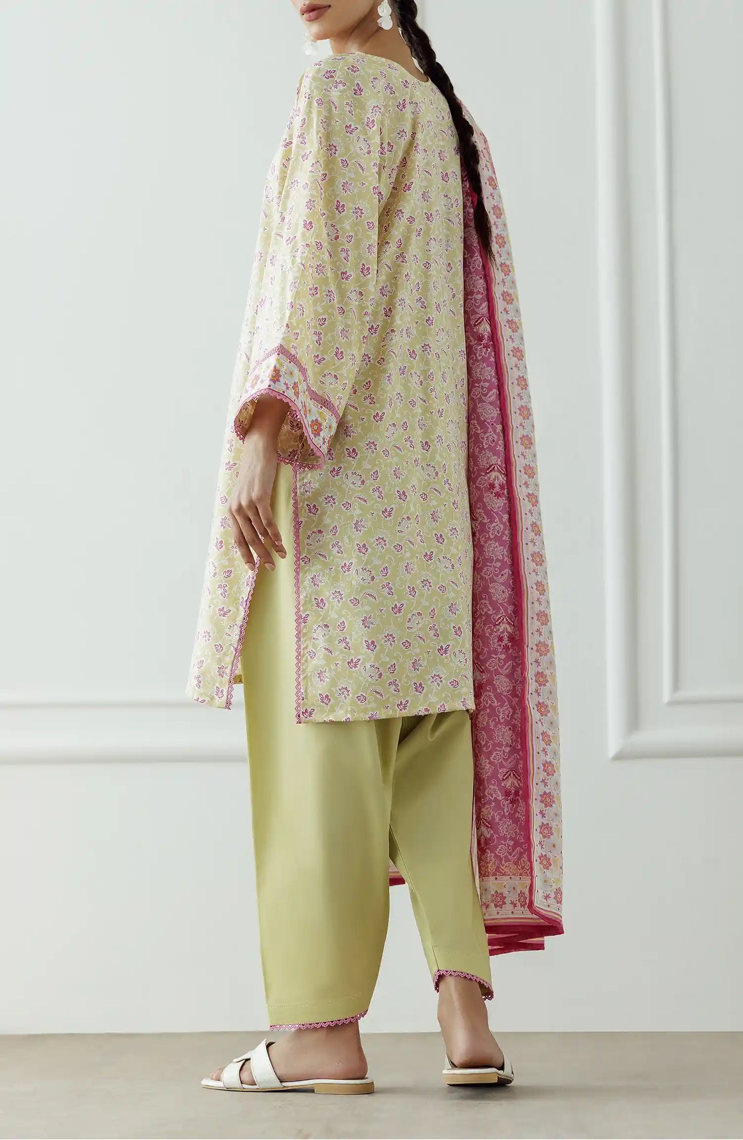 Woman wearing a traditional outfit with a floral kurta, pants, and pink dupatta against a plain trouser. Stitched Printed Lawn Shirt Dupatta & Pant - 3 Piece Suits - OTL-25-330