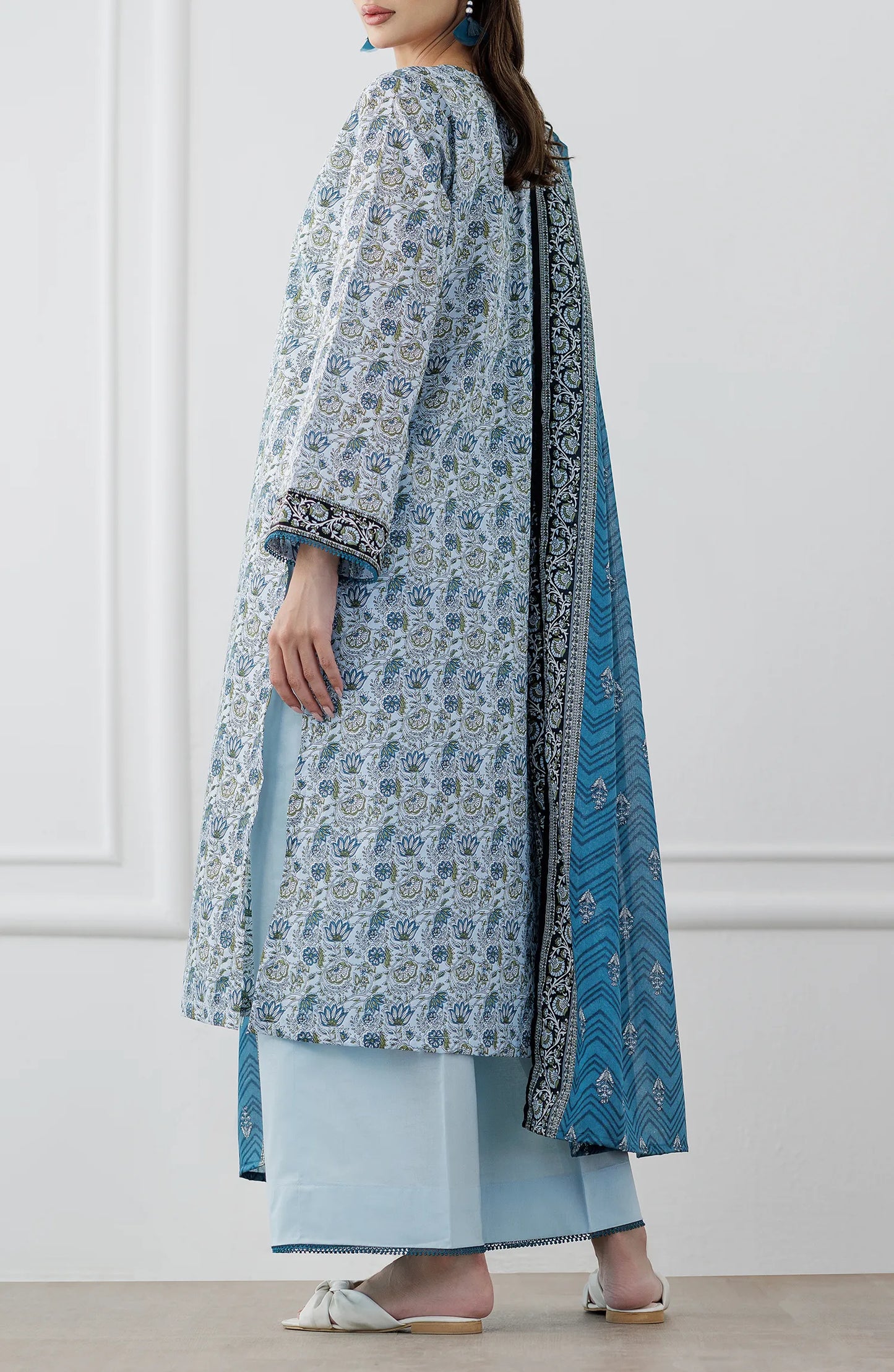 Woman wearing a blue and white patterned kurta with a matching dupatta on a dyed trouser. Stitched Printed Lawn Shirt Dupatta & Pant - 3 Piece Suits - OTL-25-347