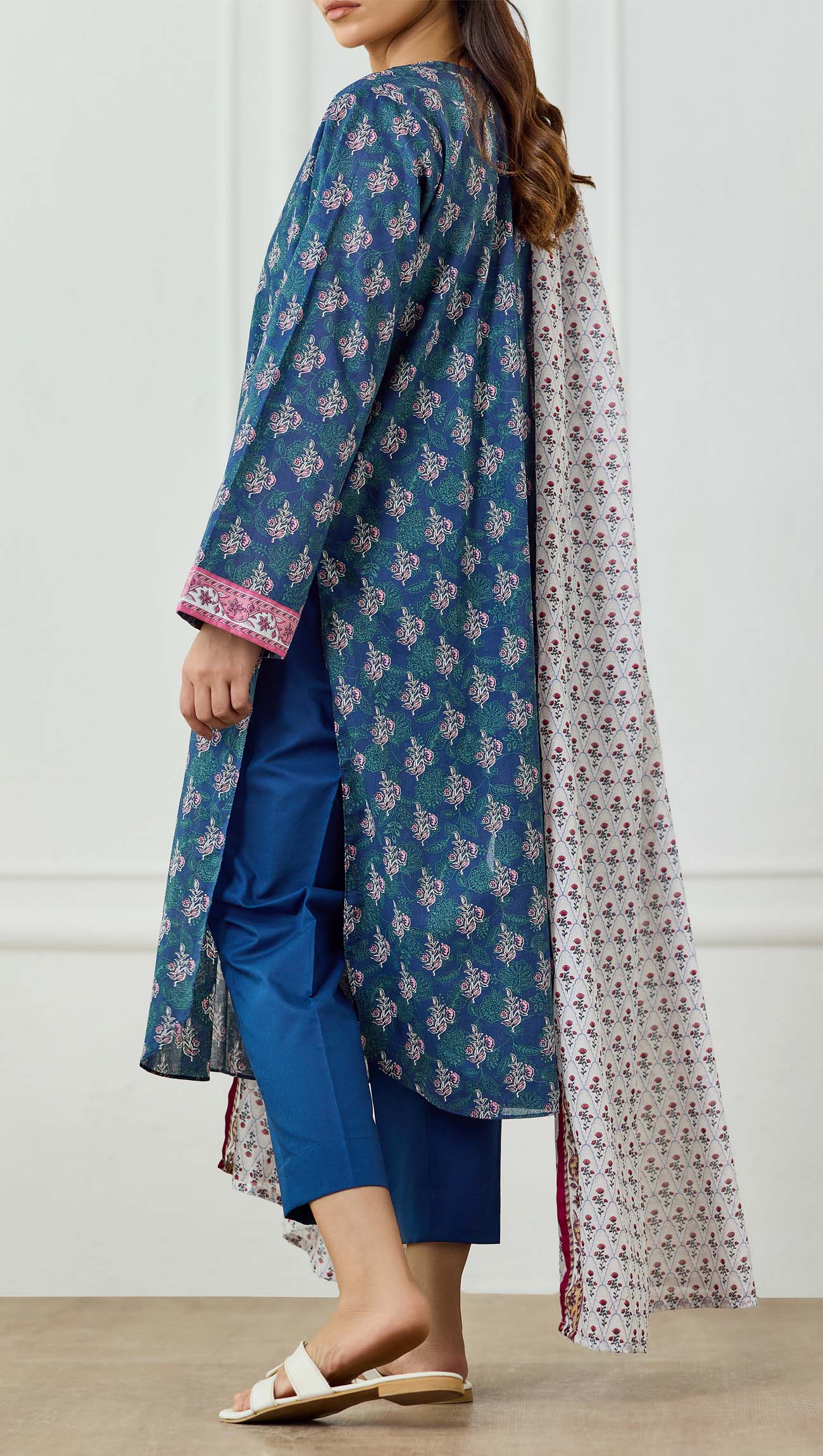 Woman wearing a blue printed kurta with a matching dupatta on a plain trouser. Unstitched Printed Lawn Shirt Dupatta & Pant - 3 Piece Suits - OTL-25-500