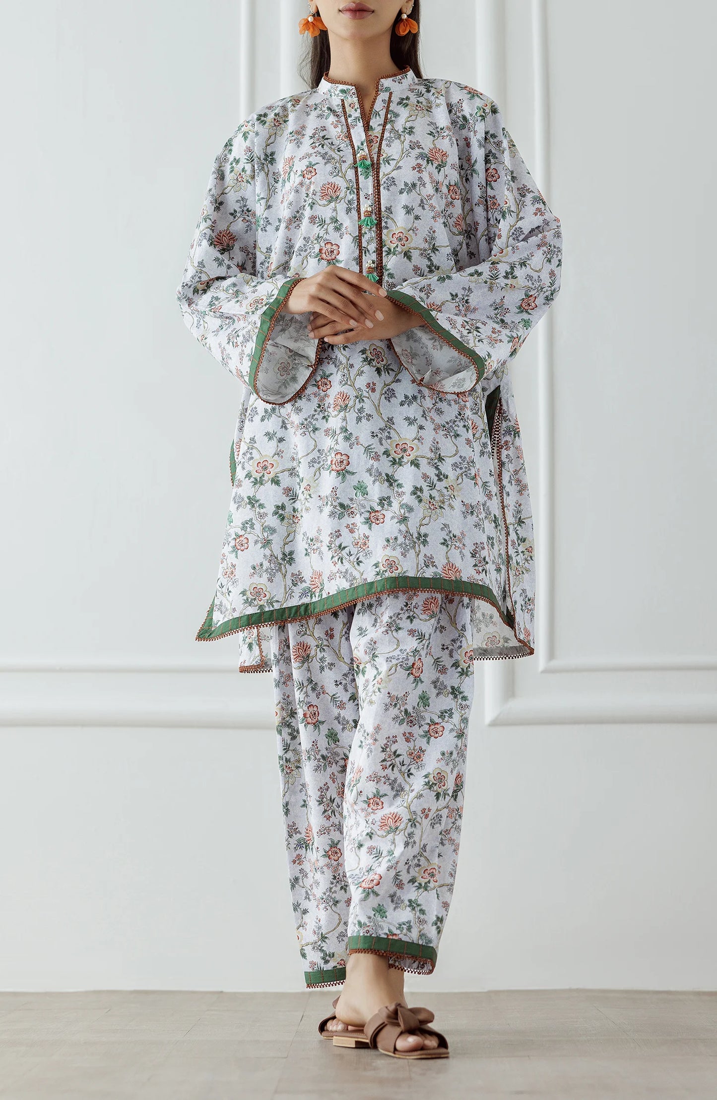 Woman wearing a floral white and beige outfit with a matching trouser. Stitched Printed Lawn Shirt & Pant - 2 Piece Suits (Co-ord Set) - WRCV25S-2029