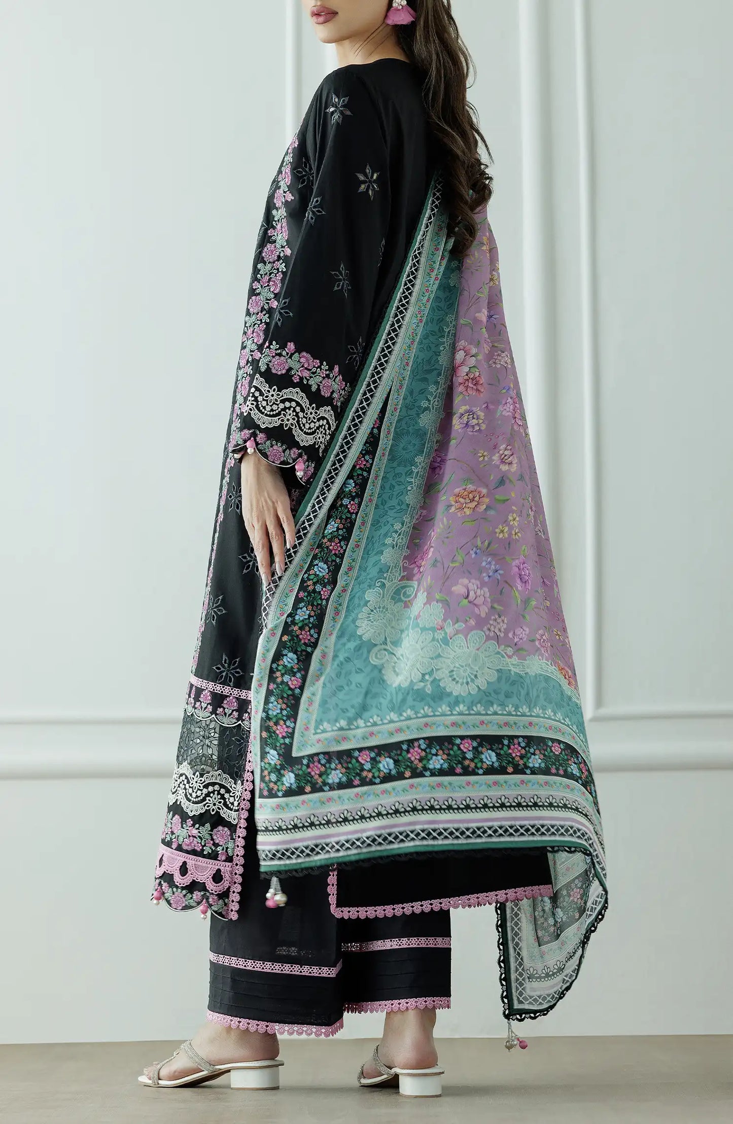 Woman wearing a black embroidered dress with pink and green dupatta against a dyed trouser. Stitched Luxury Premium Embroidered Lawn Shirt Dupatta & Pant - 3 Piece Suits - WRFC25S-3010