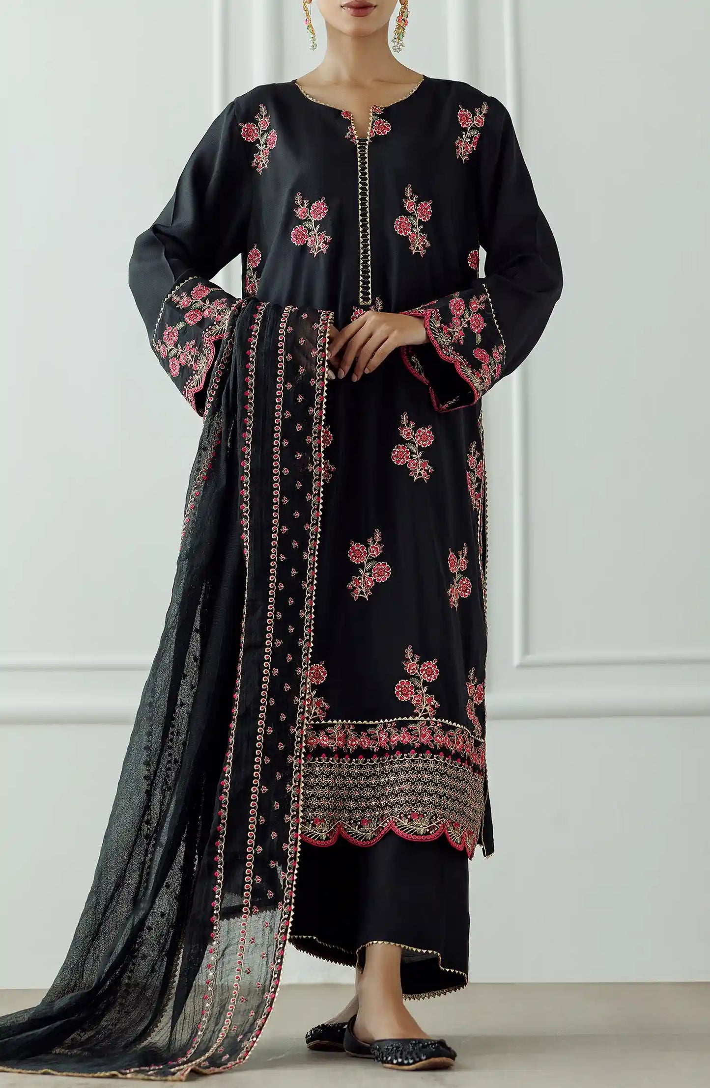 Women wearing a Black embroidered dress with pink floral patterns on a dyed trouser. Stitched Luxury Festive Formal Raw Silk Shirt Dupatta & Pant - 3 Piece Suits - WRFR24S-3017