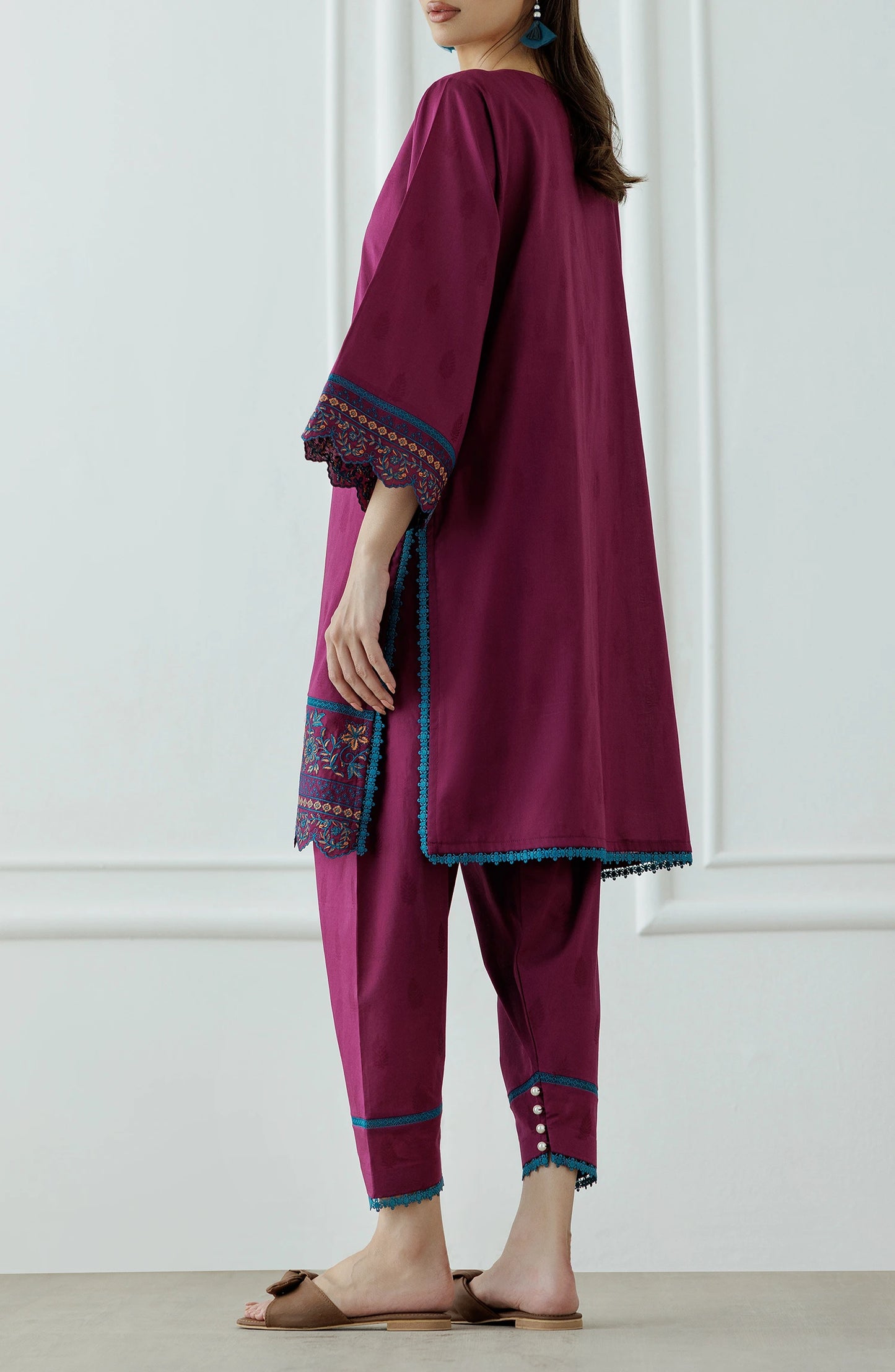 Woman wearing a magenta embroidered outfit with a lace detail dyed trouser. Stitched Luxury Premium Embroidered Lawn Shirt & Pant - 2 Piece Suits (Co-ord Set) - WRHC24S-2011