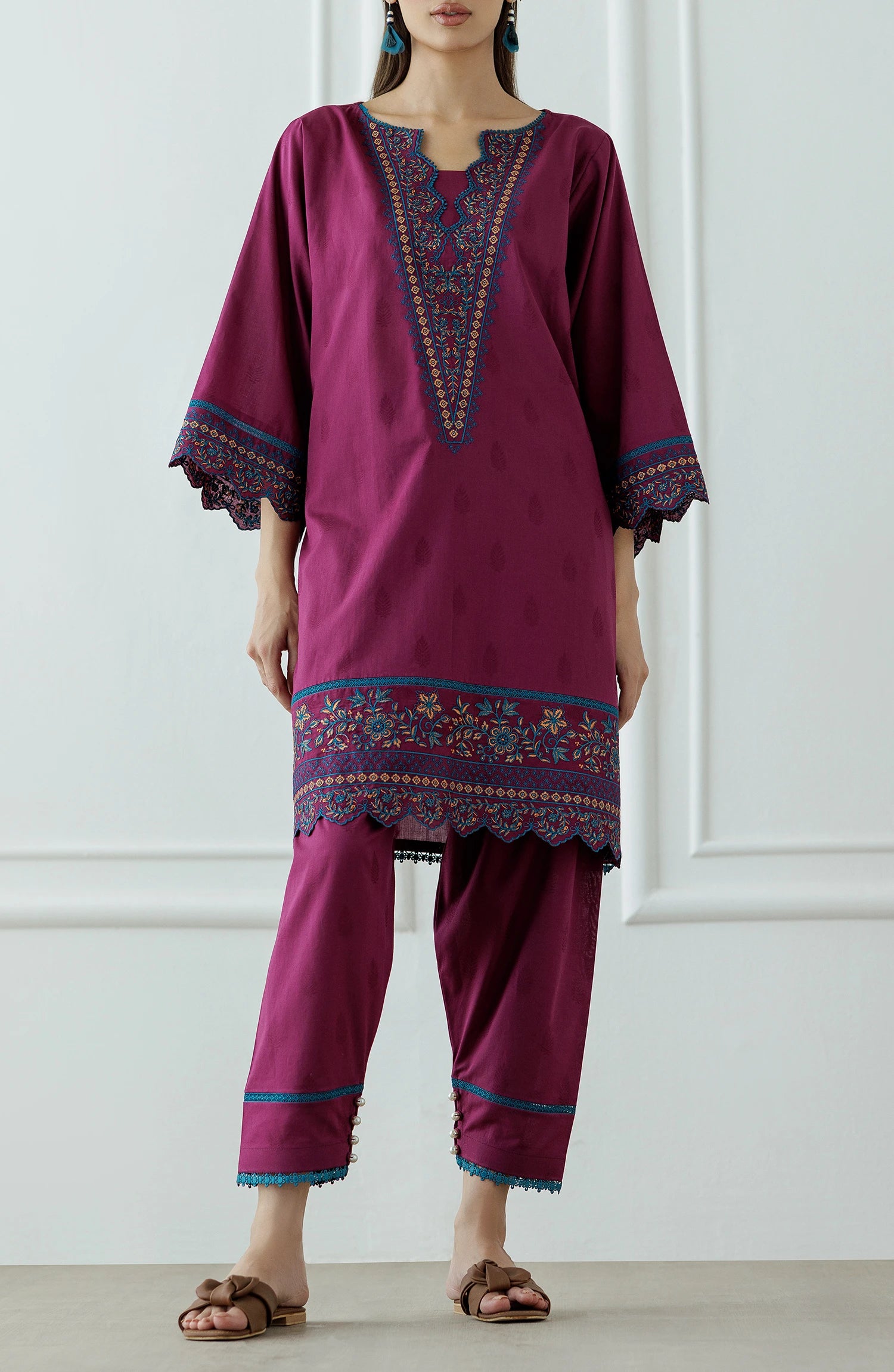 Woman wearing a magenta embroidered outfit with a lace detail dyed trouser. Stitched Luxury Premium Embroidered Lawn Shirt & Pant - 2 Piece Suits (Co-ord Set) - WRHC24S-2011