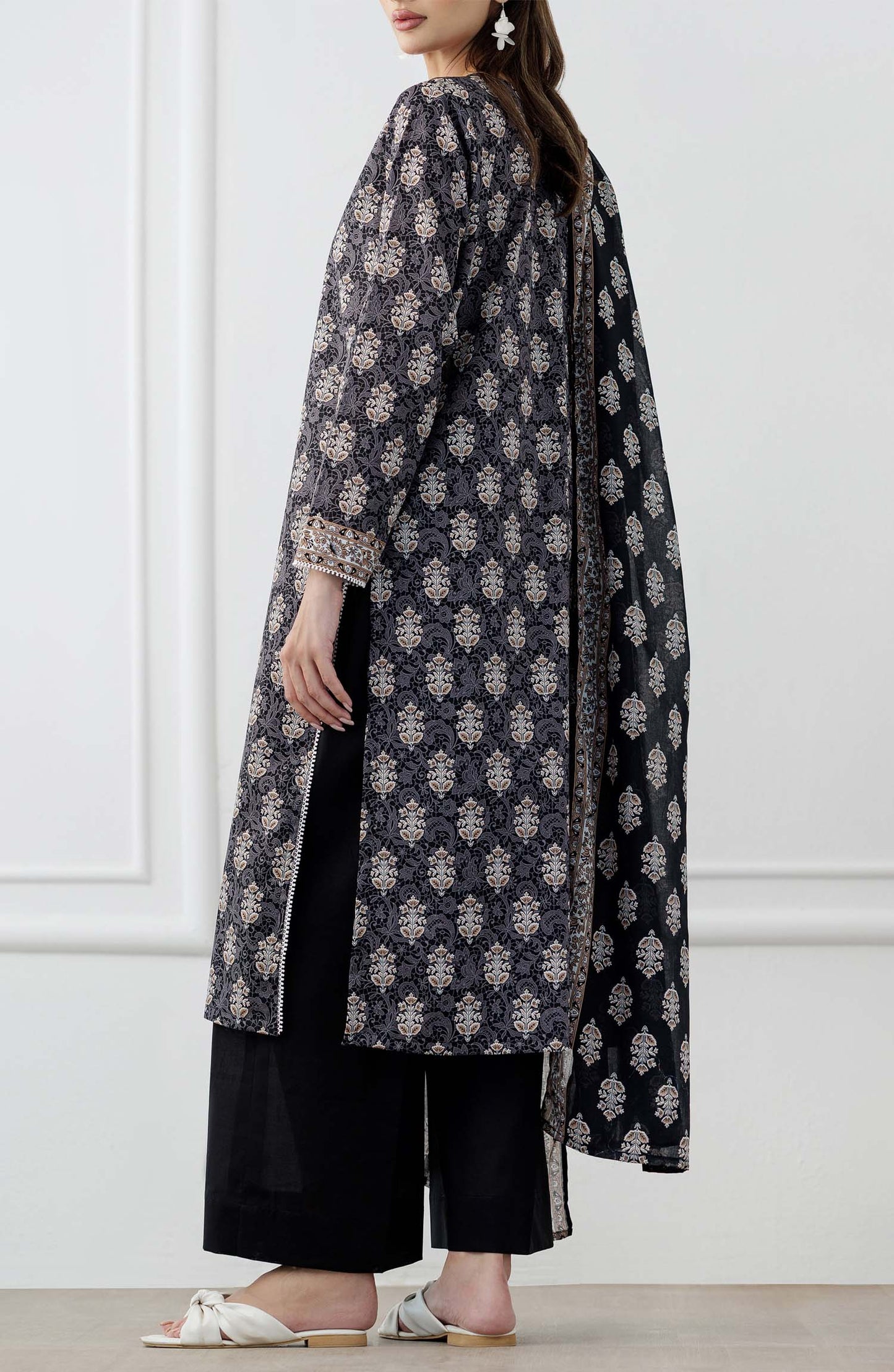 UNSTITCHED Printed Lawn Shirt Dupatta & Pant - 3 Piece Suits - OTL-25-105. Woman wearing a black and white patterned kurta with a matching dupatta in a minimalistic setting and plain trouser.