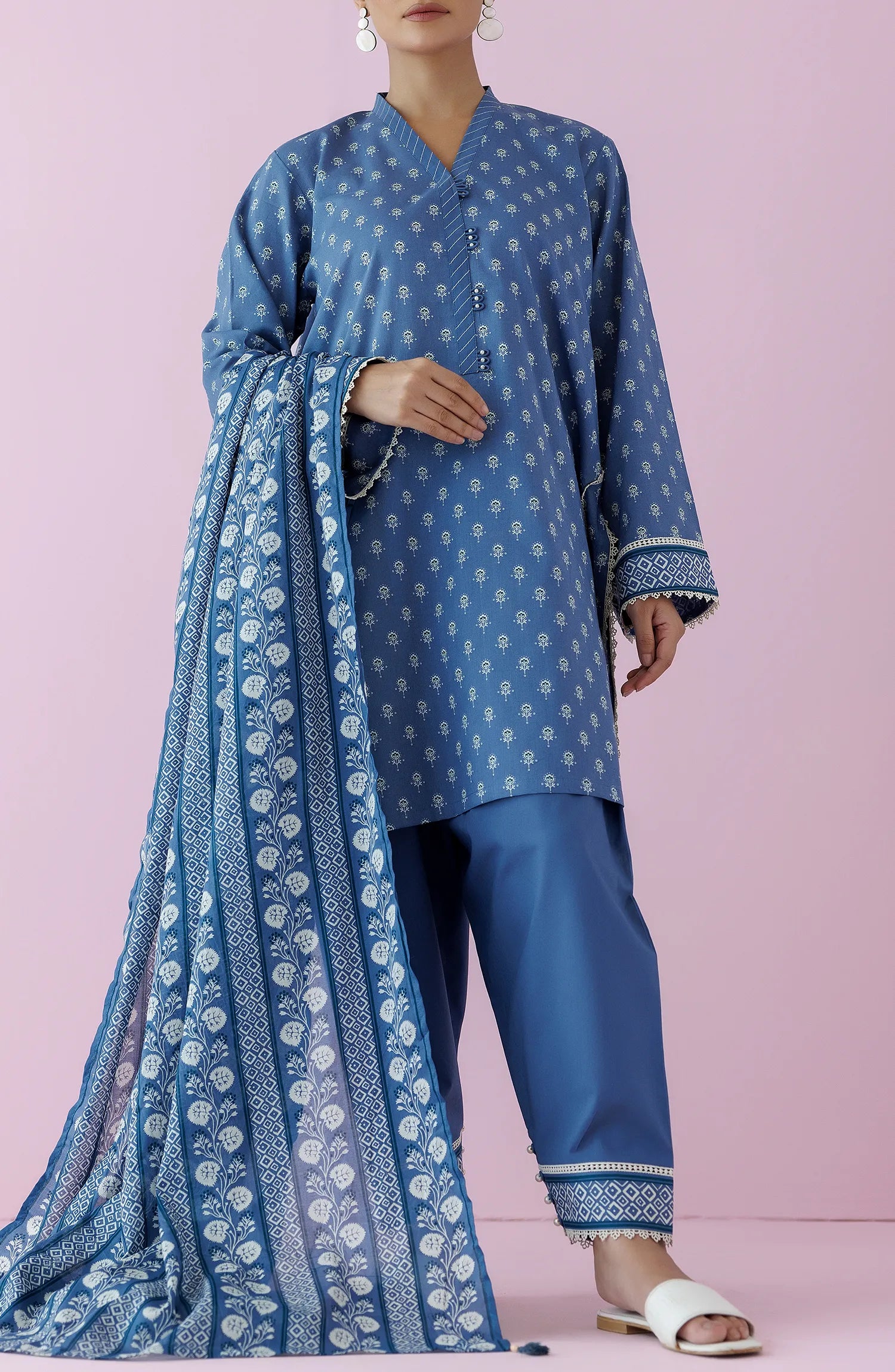 Woman wearing a blue traditional outfit with a matching dupatta on a dyed plain shalwar. Unstitched Printed Lawn Shirt Dupatta & Pant - 3 Piece Suits - OTL-20195