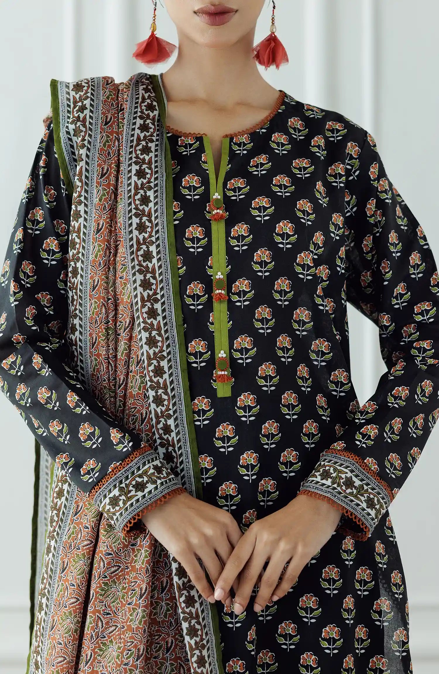 Woman wearing a black patterned kurta with a long dupatta against a black plain shalwar. UNSTITCHED Printed Lawn Shirt Dupatta & Pant - 3 Piece - OTL-25-004