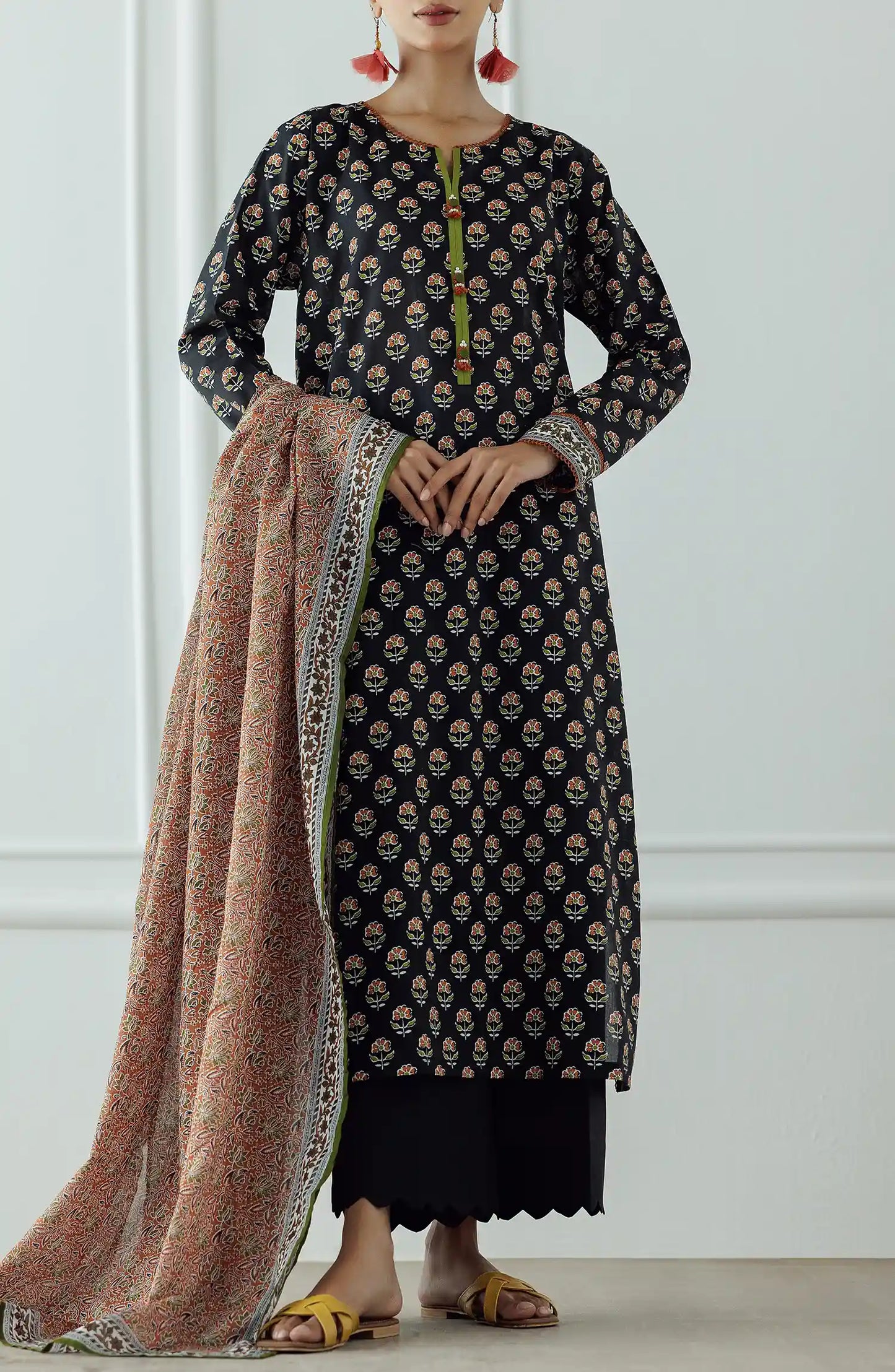 Woman wearing a black patterned kurta with a long dupatta against a black plain shalwar. UNSTITCHED Printed Lawn Shirt Dupatta & Pant - 3 Piece - OTL-25-004