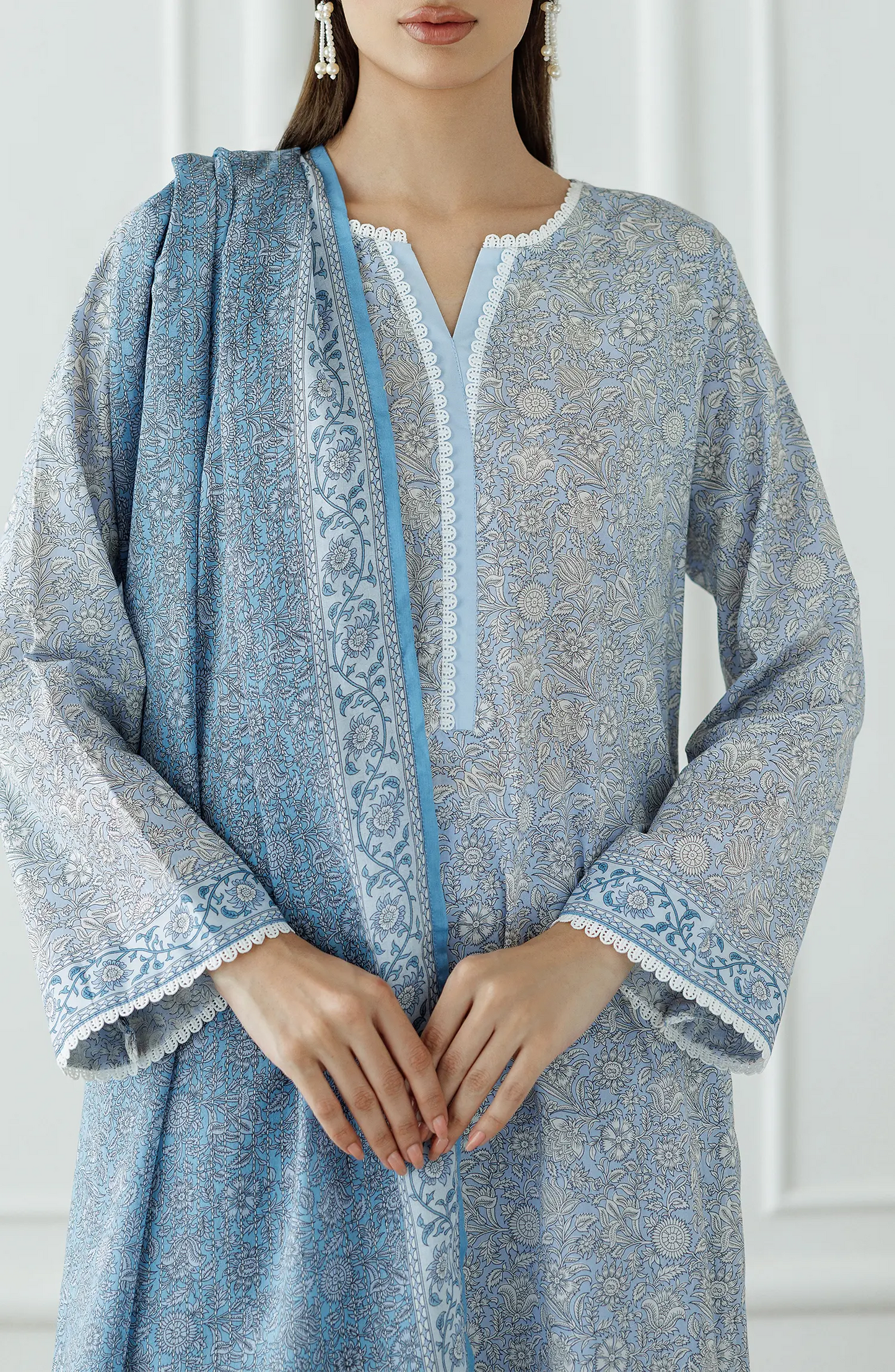 Woman wearing a blue patterned dress with white trim against a dyed trouser. UNSTITCHED Printed Lawn Shirt Dupatta & Pant - 3 Piece Suits - OTL-25-018