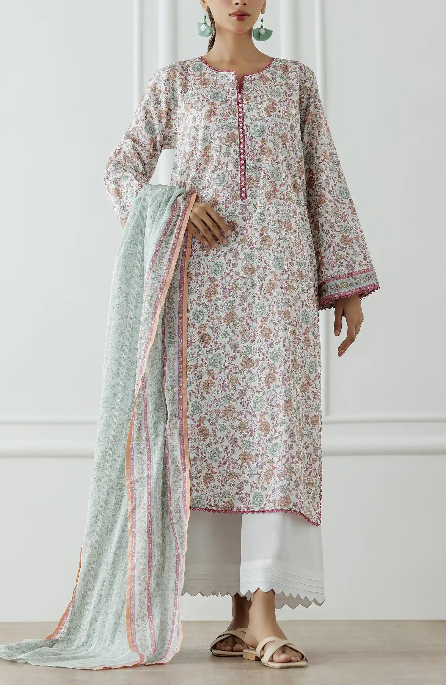 Stitched Printed Lawn Shirt Dupatta & Pant - 3 Piece - OTL-25-020. Woman wearing a floral kurta with a long green scarf against a white wall.