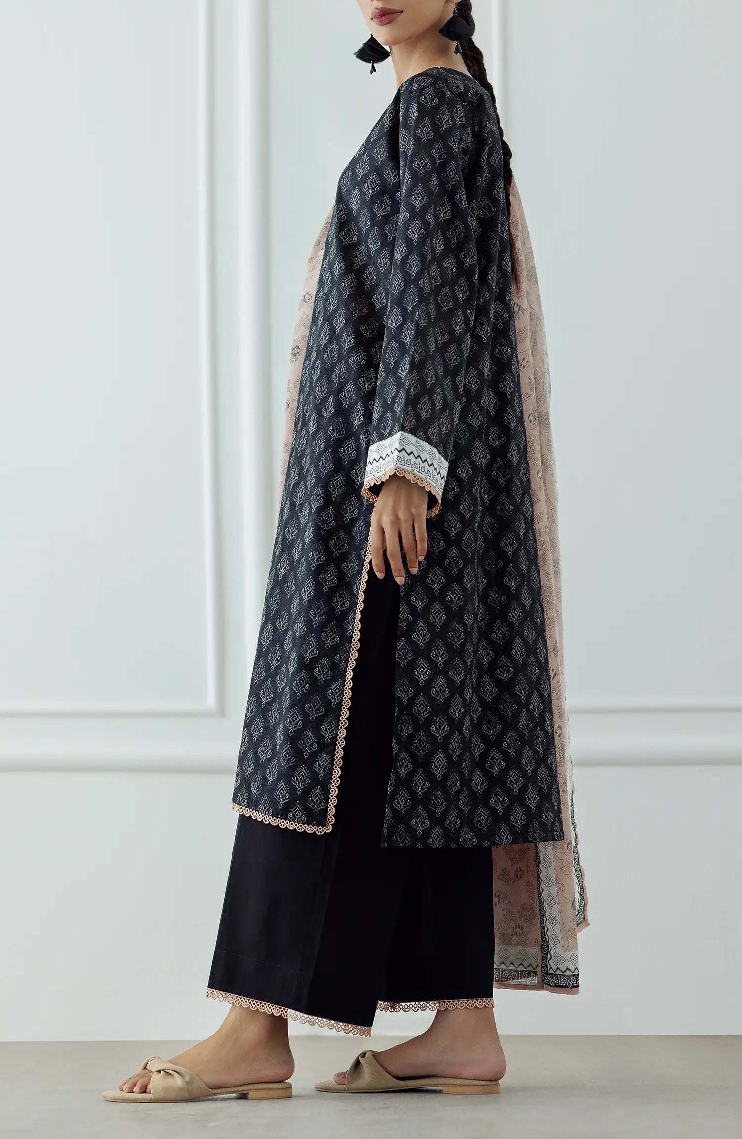 UNSTITCHED Printed Lawn Shirt Dupatta & Pant - 3 Piece - OTL-25-023. Woman wearing a black patterned kurta with a matching dupatta plain black shalwar.