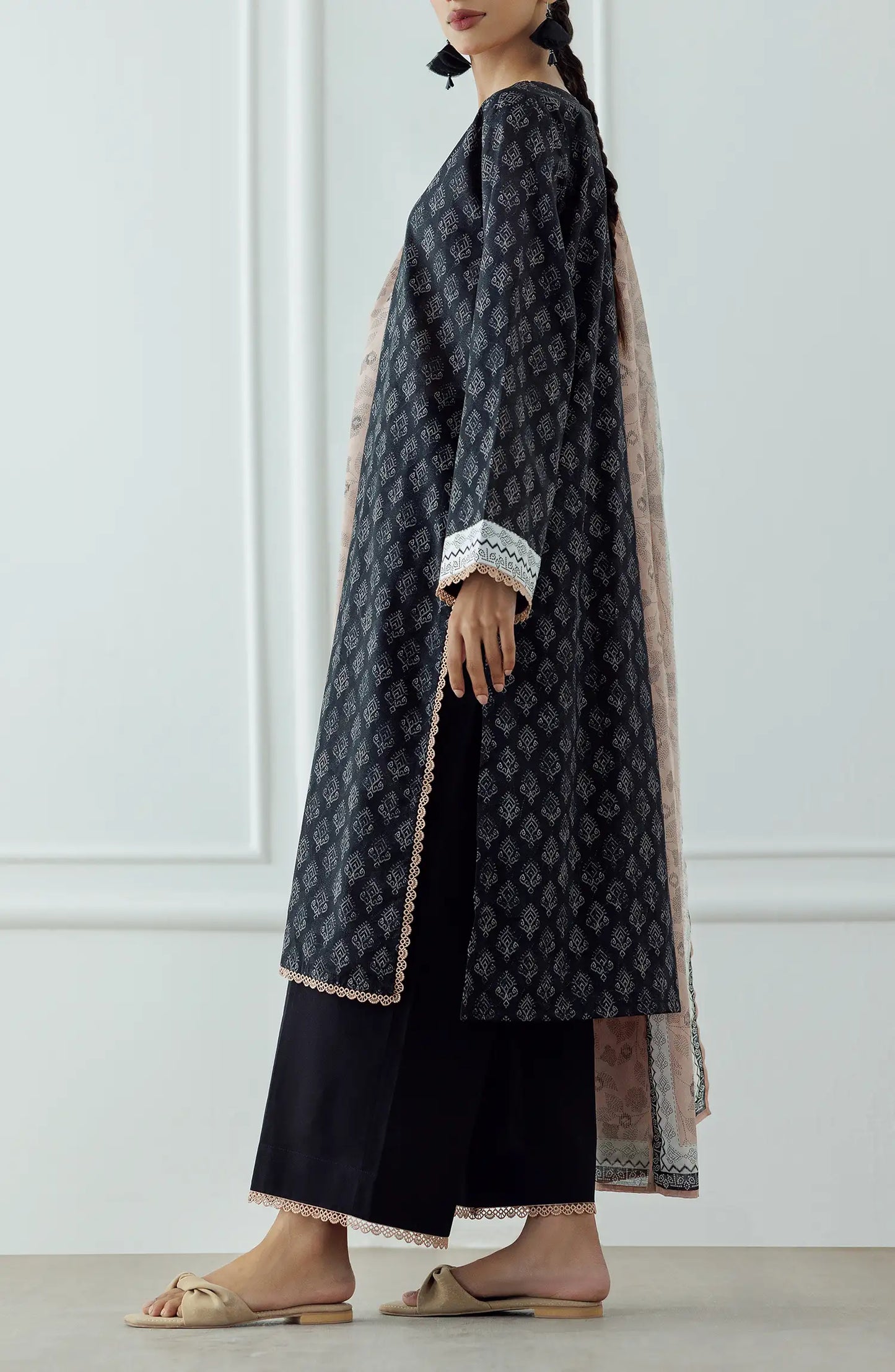 UNSTITCHED Printed Lawn Shirt Dupatta & Pant - 3 Piece - OTL-25-023. Woman wearing a black patterned kurta with a matching dupatta plain black shalwar.