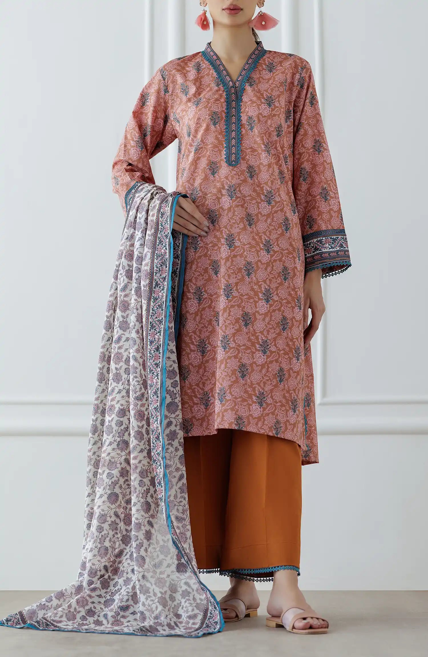 Woman wearing a pink and orange traditional outfit with a patterned dupatta on a plain trouser. Stitched Printed Lawn Shirt Dupatta & Pant - 3 Piece Suits - OTL-25-027