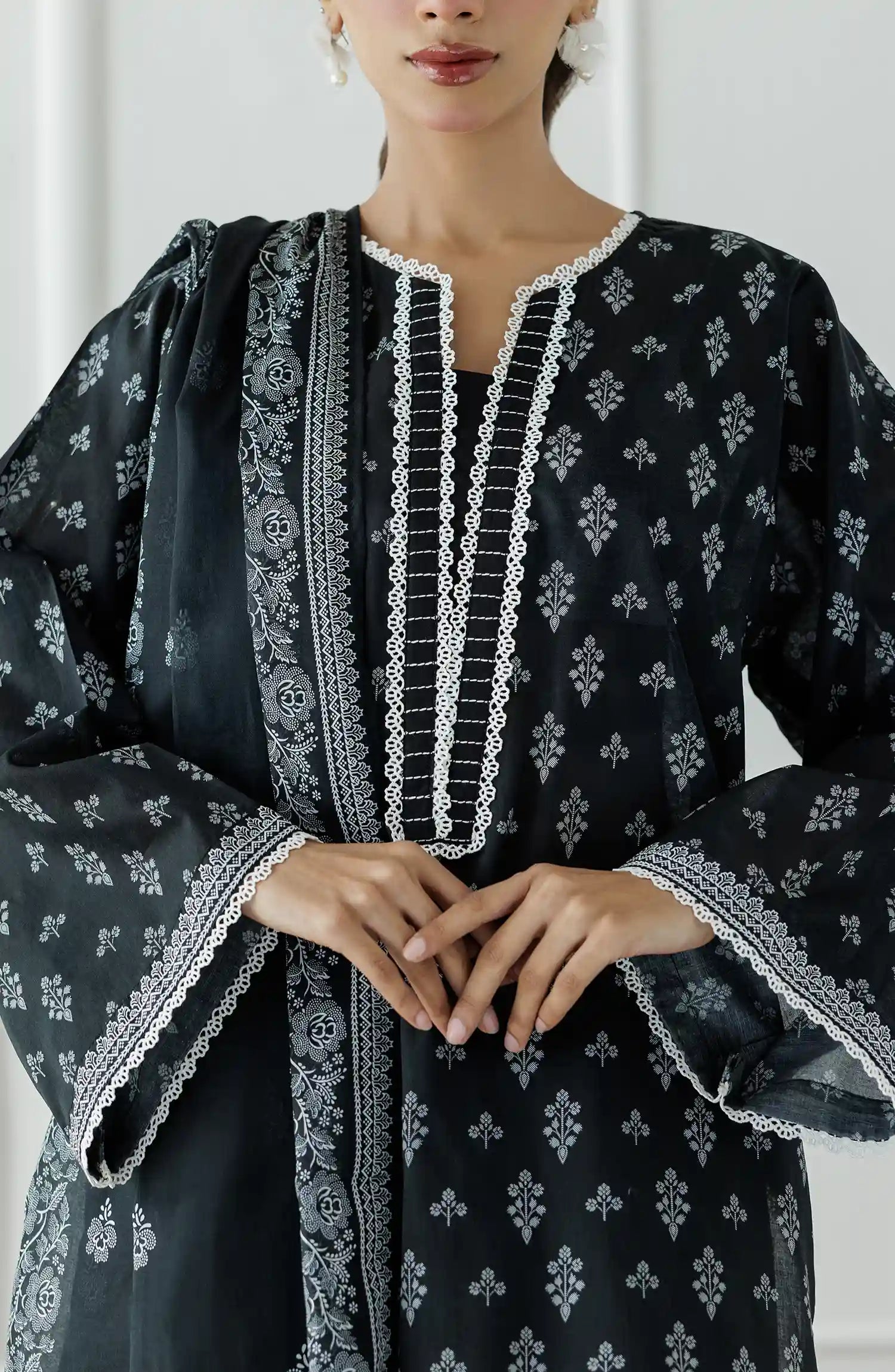 Woman wearing a black and white patterned kurta with black pants and a matching dupatta on a plain farshi shalwar. Stitched Printed Lawn Shirt Dupatta & Pant - 3 Piece Suits - OTL-25-030