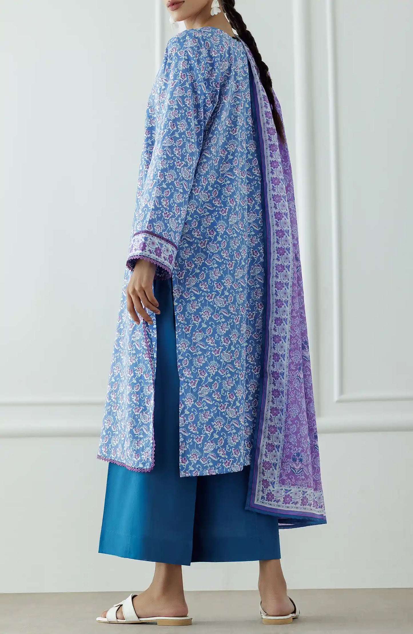 Woman wearing a blue floral kurta with a matching dupatta and blue pants against a plain trouser. Stitched Printed Lawn Shirt Dupatta & Pant - 3 Piece Suits - OTL-25-043