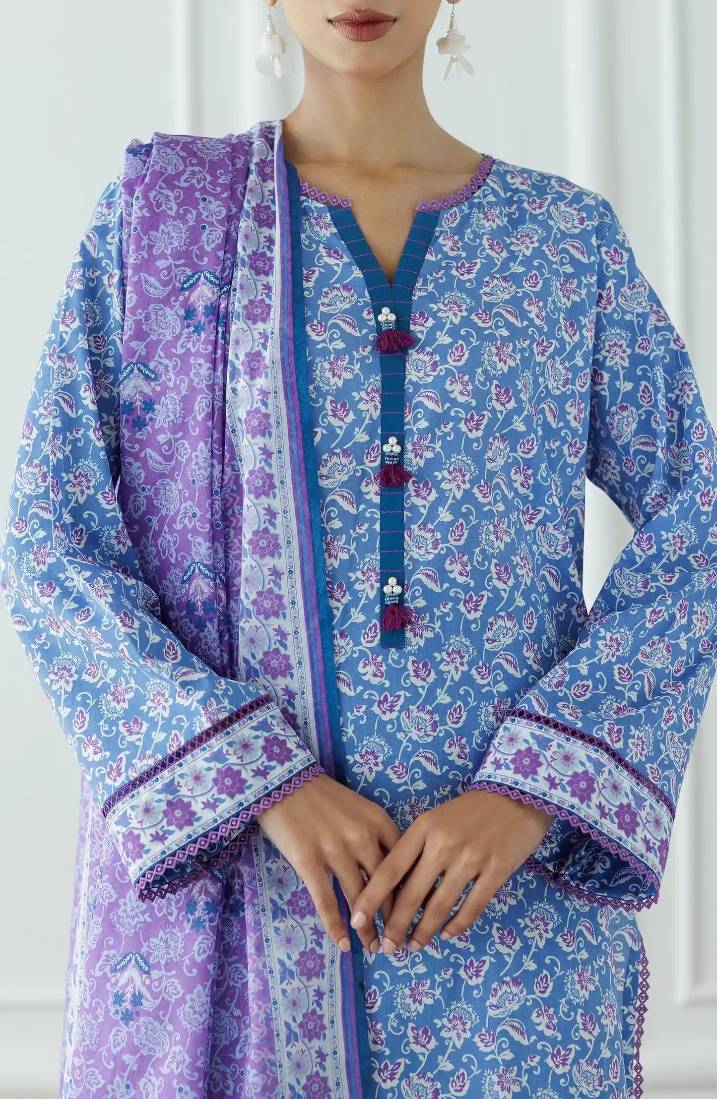 Woman wearing a blue floral kurta with a matching dupatta and blue pants against a plain trouser. Stitched Printed Lawn Shirt Dupatta & Pant - 3 Piece Suits - OTL-25-043