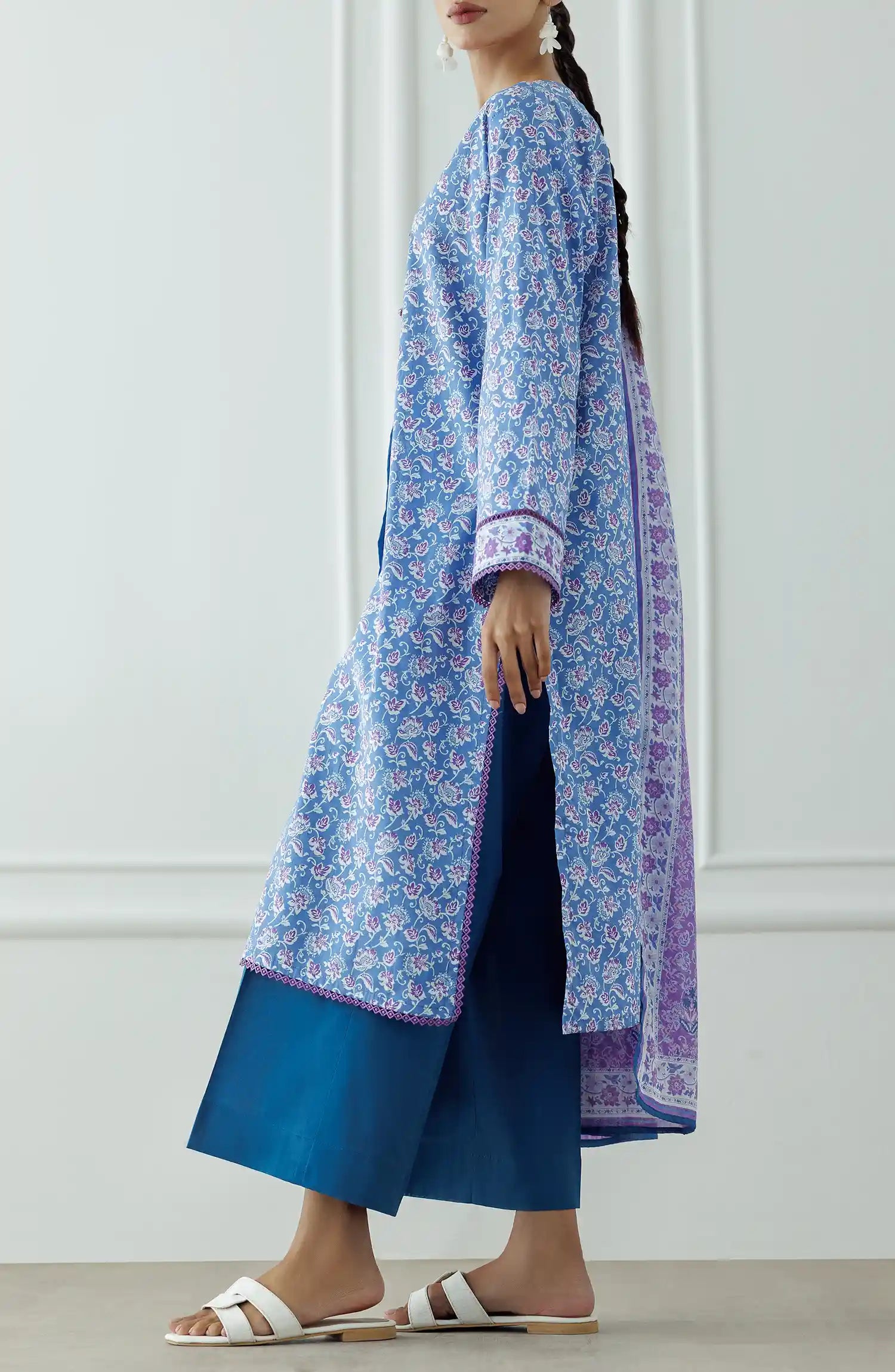 Woman wearing a blue floral kurta with a matching dupatta and blue pants against a plain trouser. Stitched Printed Lawn Shirt Dupatta & Pant - 3 Piece Suits - OTL-25-043
