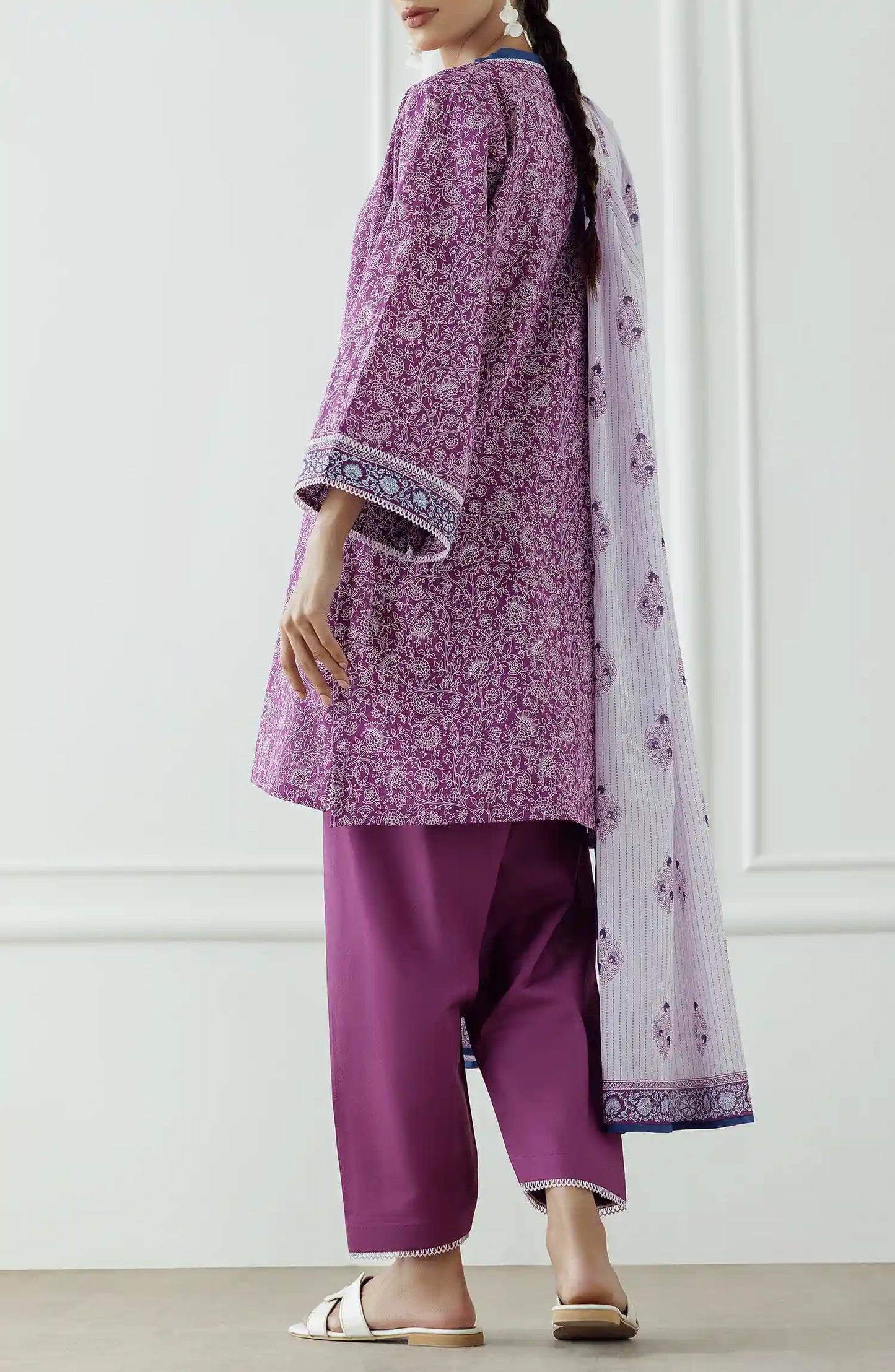Woman wearing a purple traditional outfit with a white dupatta against a classic traditional shalwar. Stitched Printed Lawn Shirt Dupatta & Pant - 3 Piece - OTL-25-051