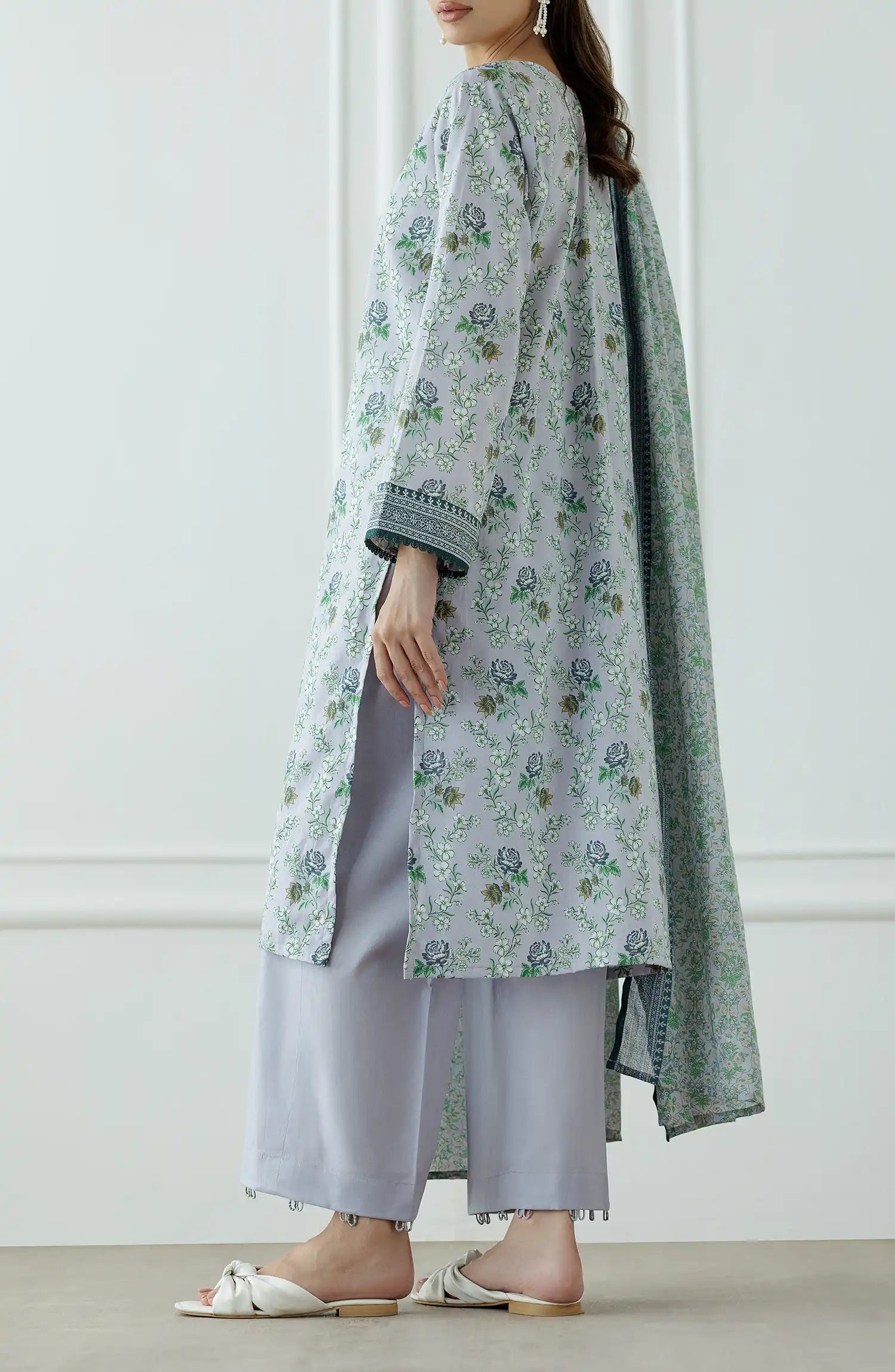 Woman wearing a floral kurta with a matching dupatta against a plain trouser. Stitched Printed Lawn Shirt Dupatta & Pant - 3 Piece Suits - OTL-25-059