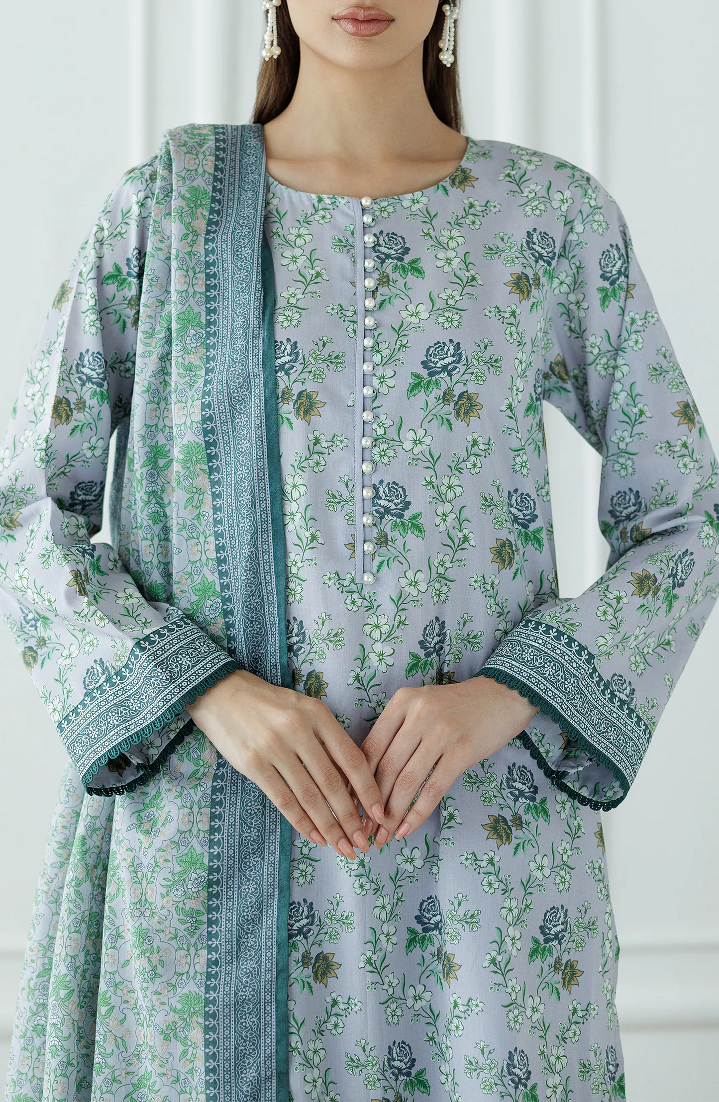 Woman wearing a floral kurta with a matching dupatta against a plain trouser. Stitched Printed Lawn Shirt Dupatta & Pant - 3 Piece Suits - OTL-25-059