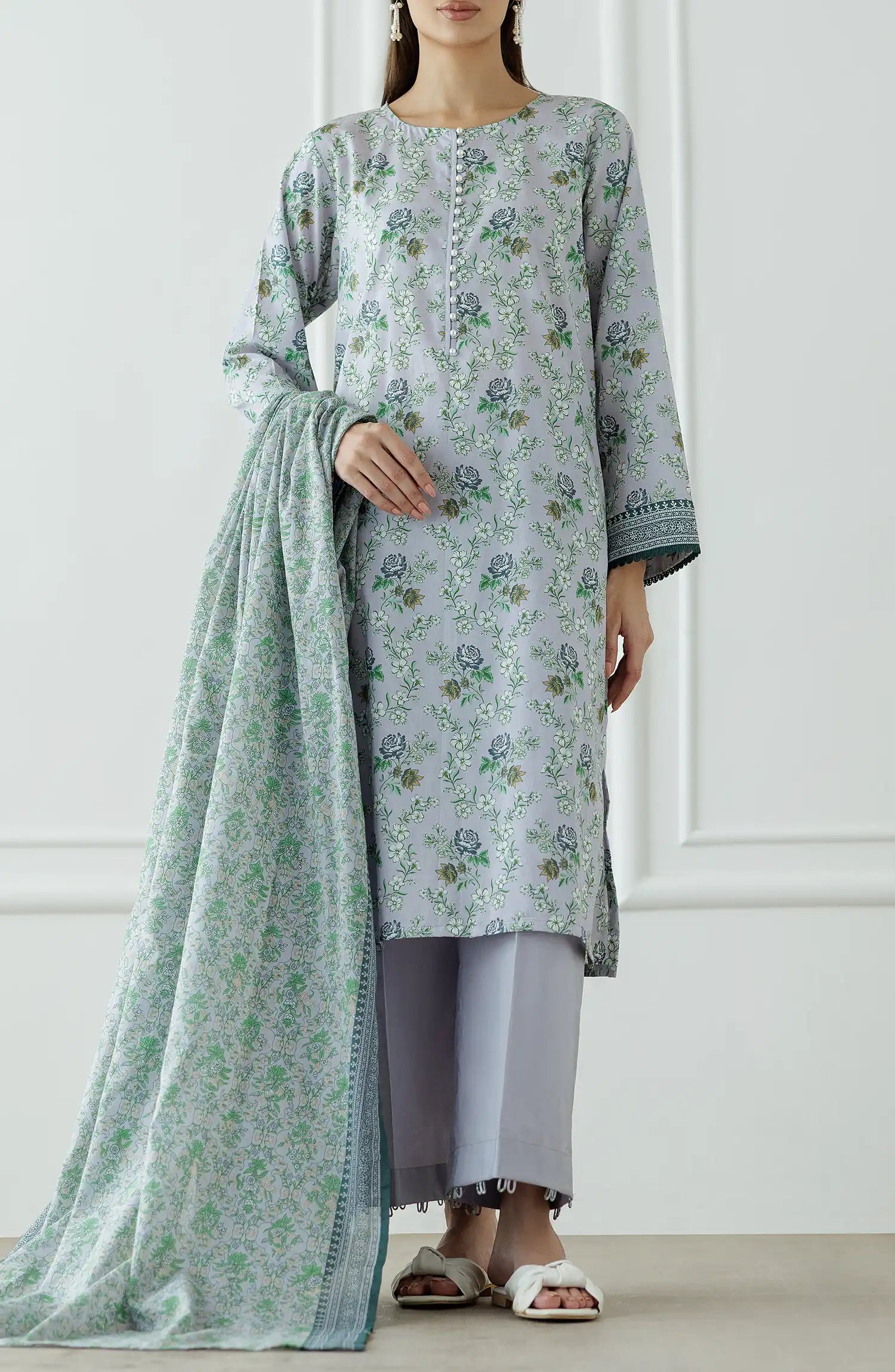 Woman wearing a floral kurta with a matching dupatta against a plain trouser. Stitched Printed Lawn Shirt Dupatta & Pant - 3 Piece Suits - OTL-25-059