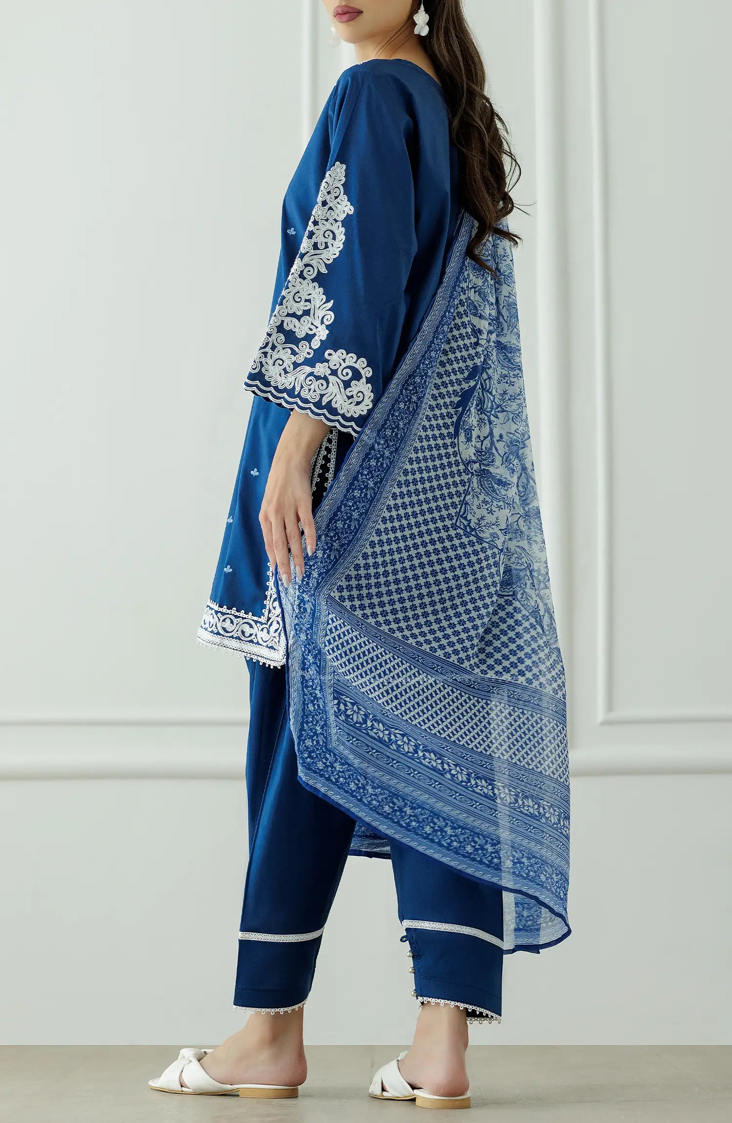 Woman wearing a blue embroidered outfit with a matching dupatta against a dyed trouser. Stitched Luxury Festive Formal Lawn Shirt Dupatta & Pant - 3 Piece Suits - OTL-25-082