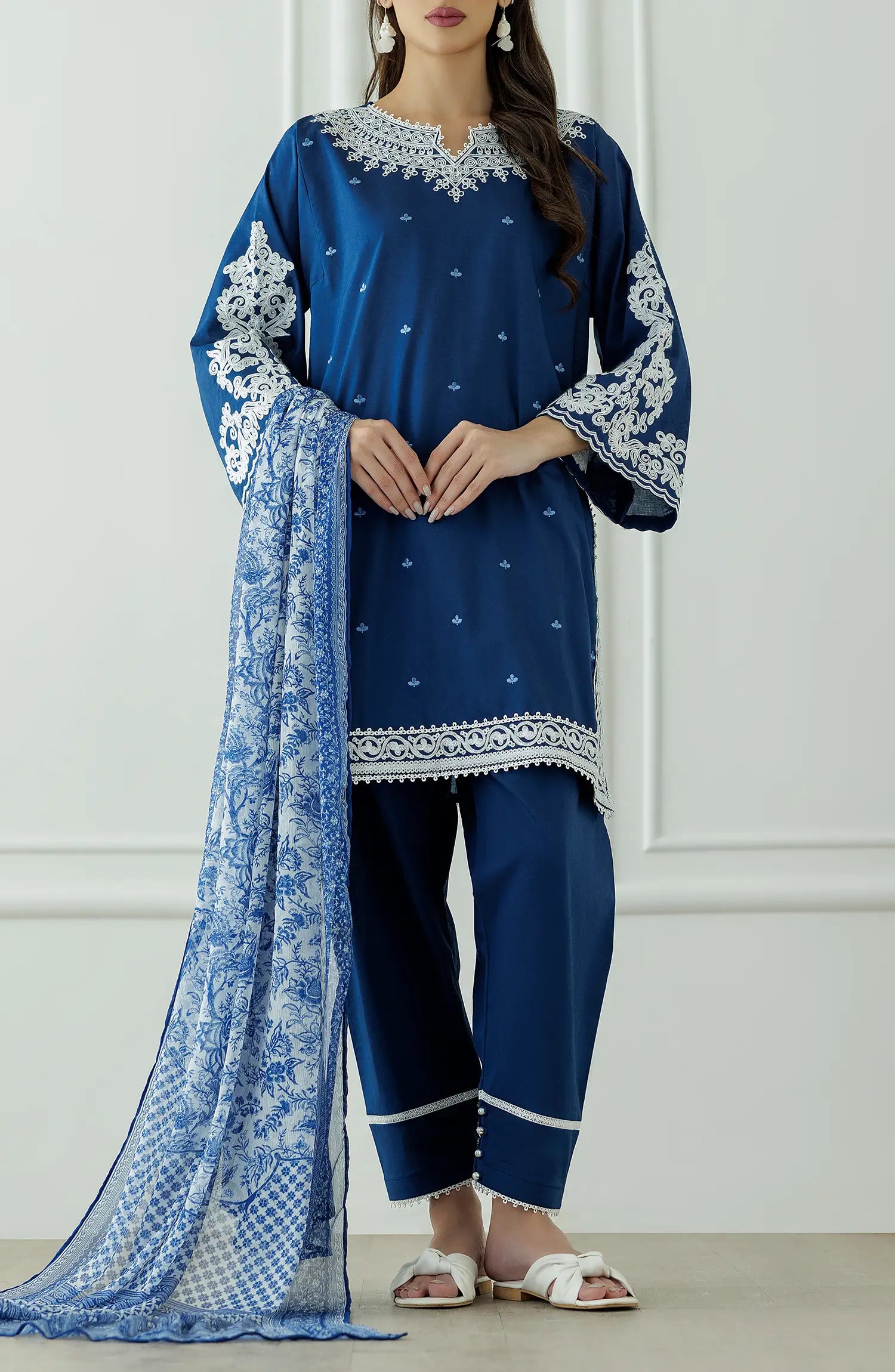 Woman wearing a blue embroidered outfit with a matching dupatta against a dyed trouser. Stitched Luxury Festive Formal Lawn Shirt Dupatta & Pant - 3 Piece Suits - OTL-25-082