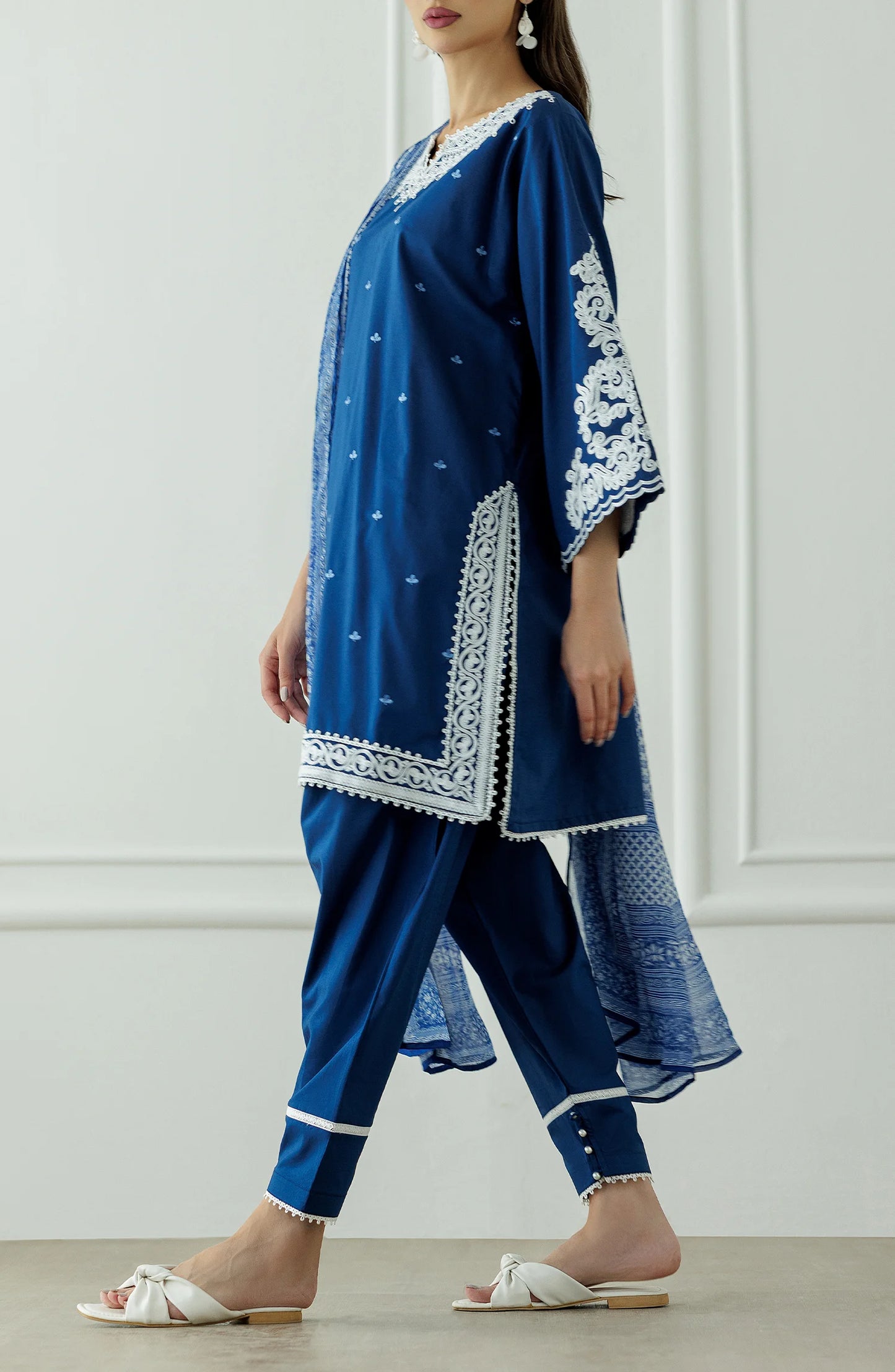 Woman wearing a blue embroidered outfit with a matching dupatta against a dyed trouser. Stitched Luxury Festive Formal Lawn Shirt Dupatta & Pant - 3 Piece Suits - OTL-25-082