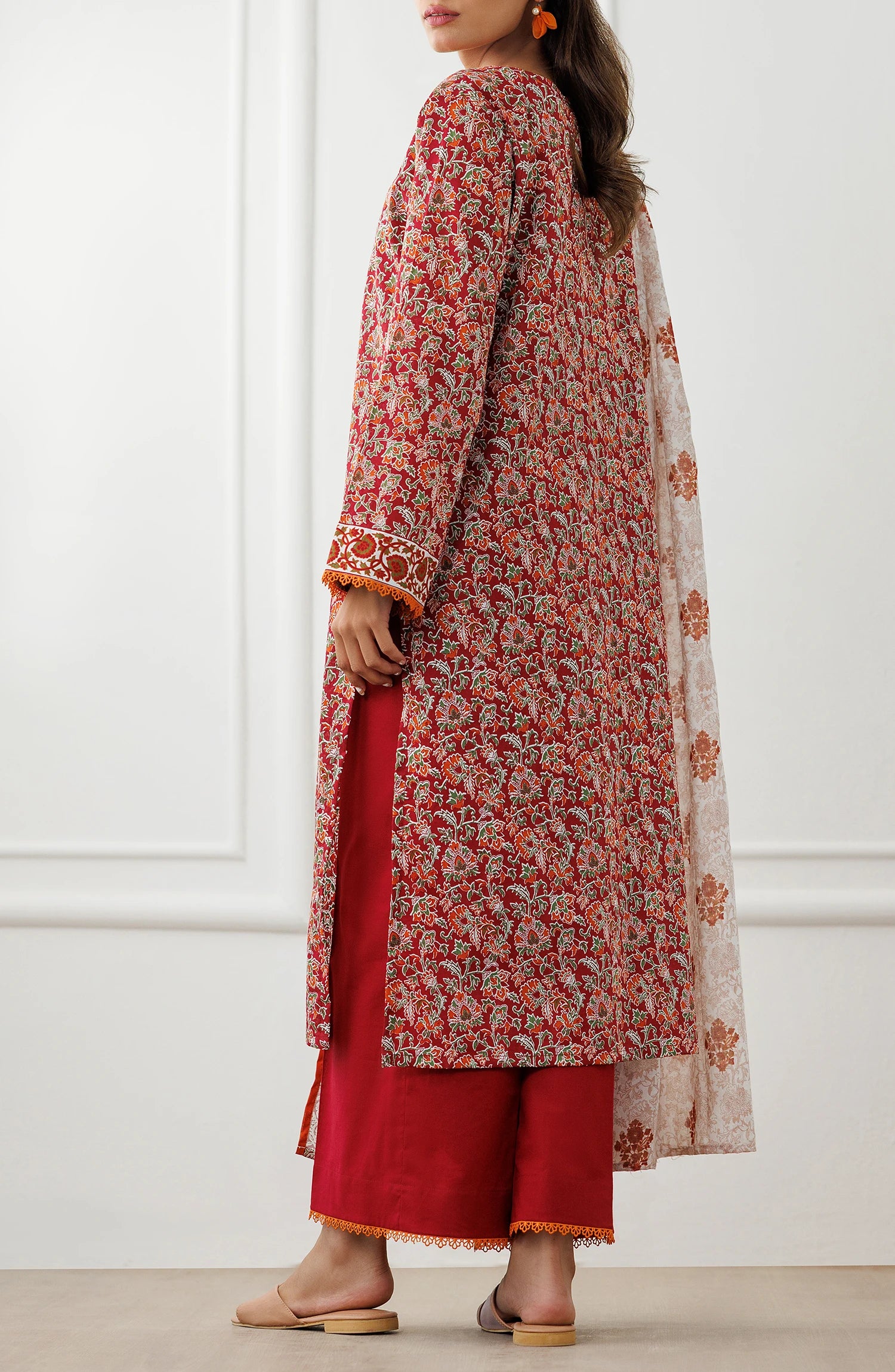Woman wearing a red floral dress with matching pants and a white dupatta in a dyed trouser. Unstitched Printed Lawn Shirt Dupatta & Pant - 3 Piece Suits - OTL-25-096
