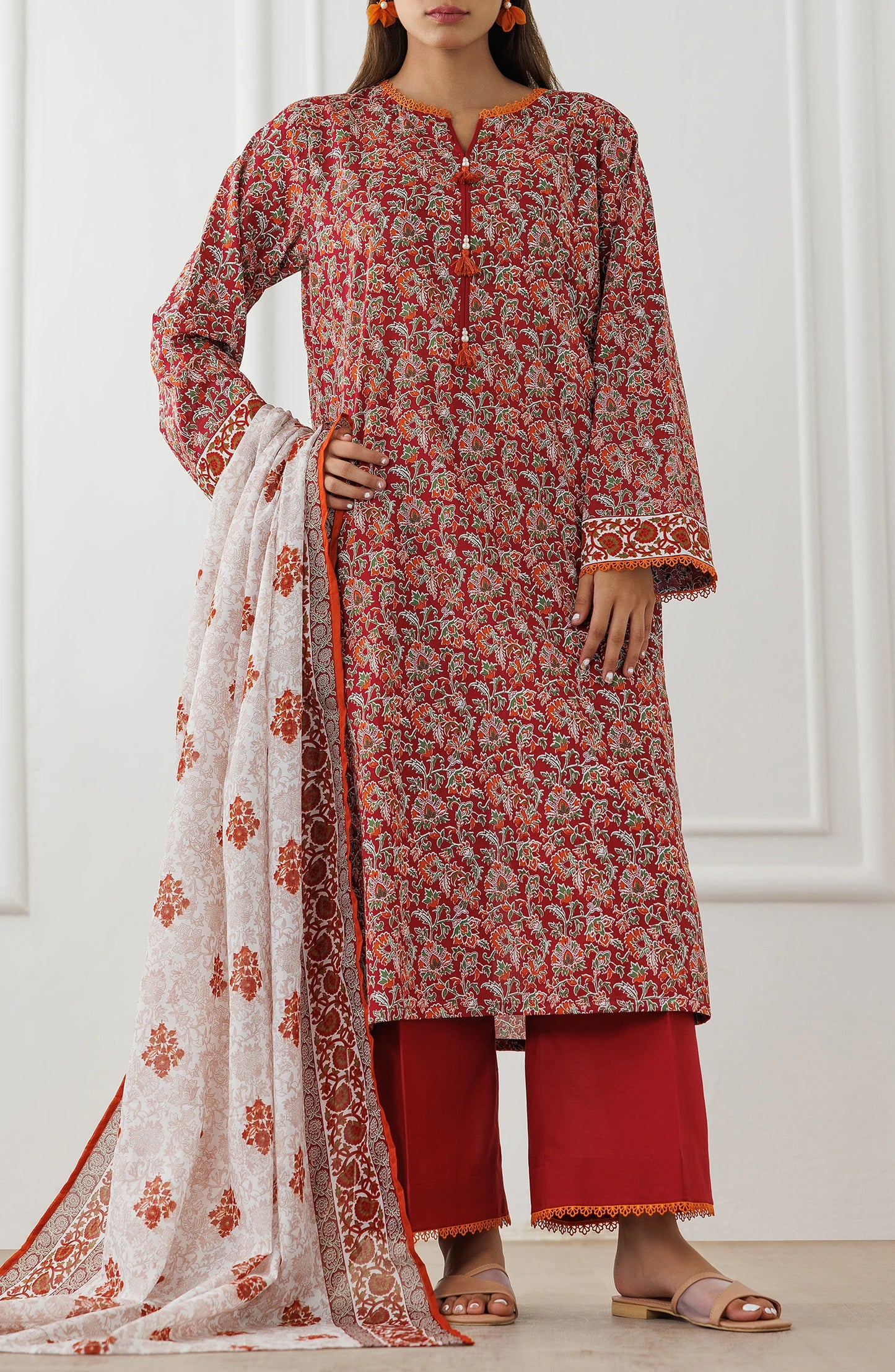 Woman wearing a red floral dress with matching pants and a white dupatta in a dyed trouser. Unstitched Printed Lawn Shirt Dupatta & Pant - 3 Piece Suits - OTL-25-096