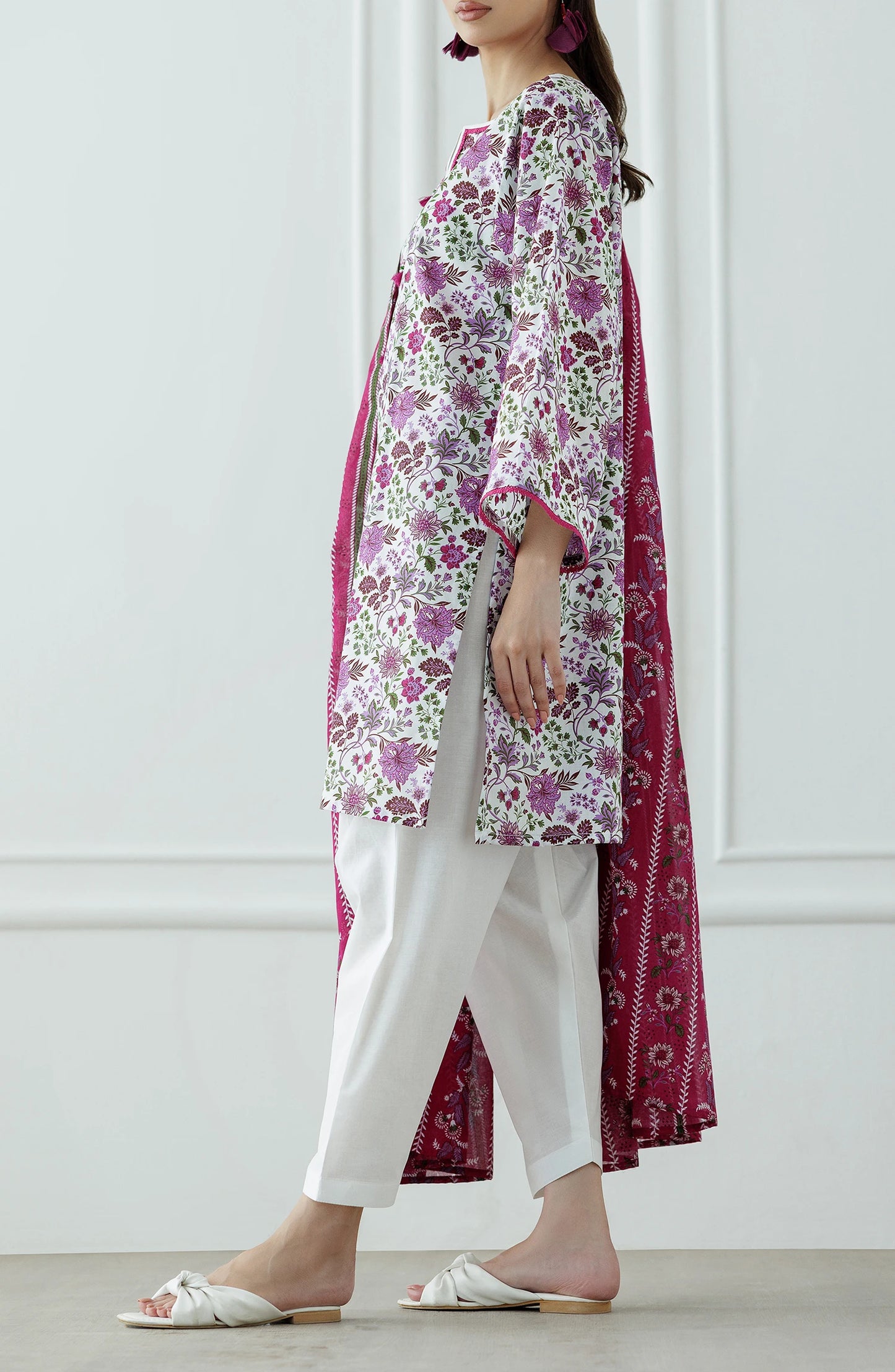 Woman wearing a floral kurta with white pants and a pink dupatta with plain shalwar trouser. Stitched Printed Lawn Shirt Dupatta & Pant - 3 Piece Suits - OTL-25-099