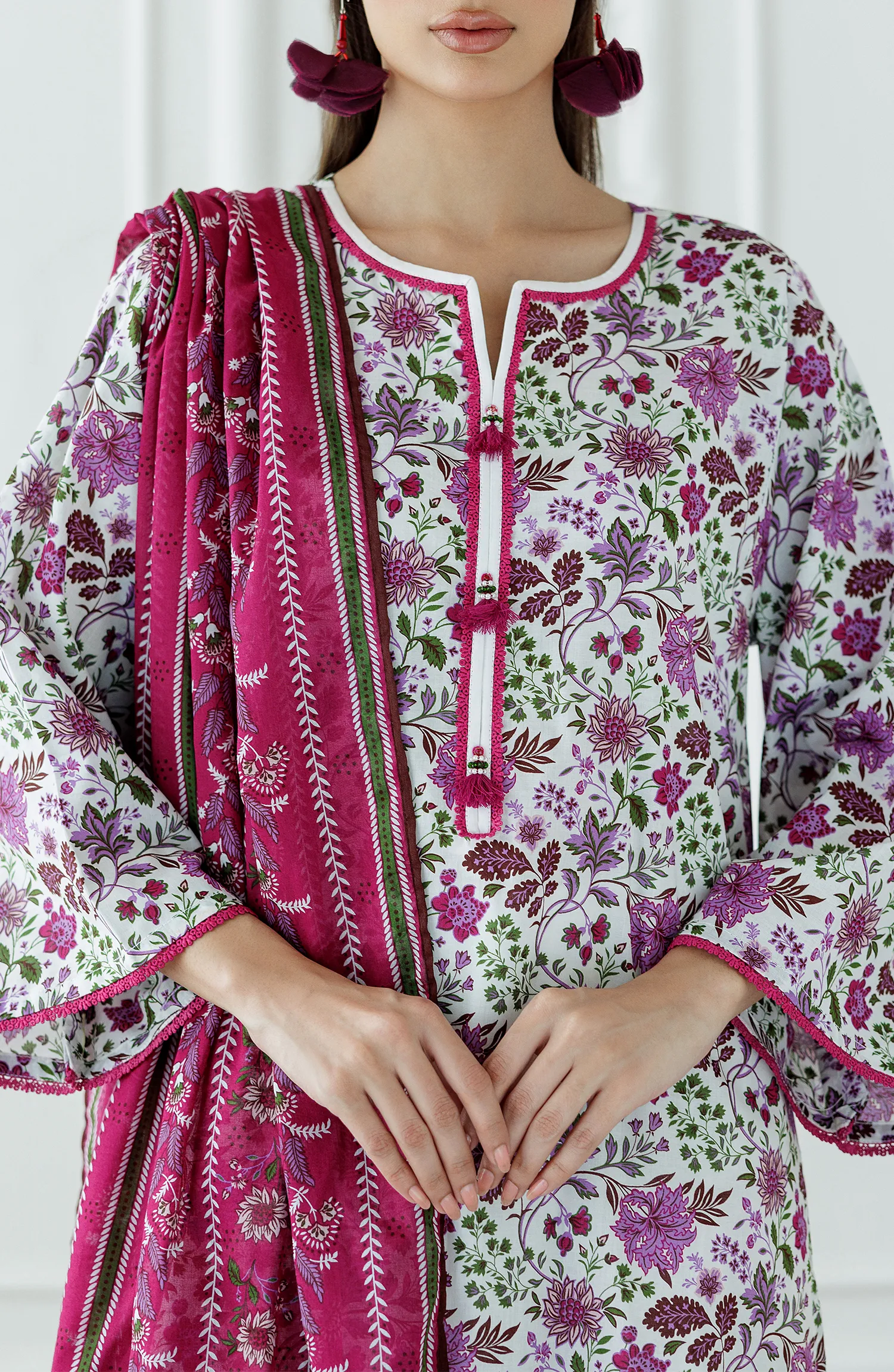Woman wearing a floral kurta with white pants and a pink dupatta with plain shalwar trouser. Stitched Printed Lawn Shirt Dupatta & Pant - 3 Piece Suits - OTL-25-099