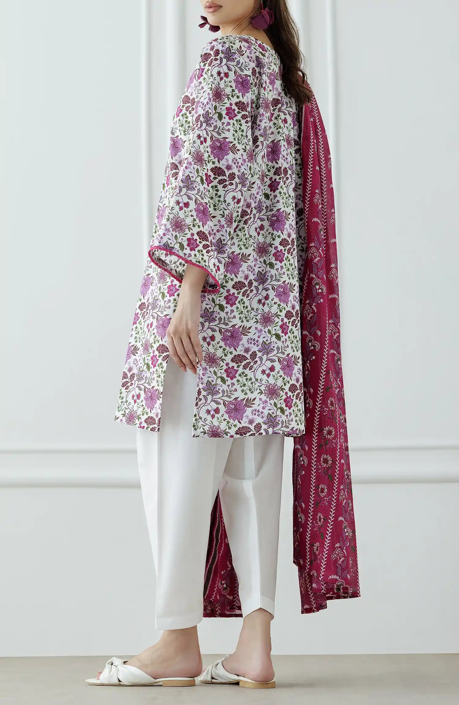 Woman wearing a floral kurta with white pants and a pink dupatta with plain shalwar trouser. Stitched Printed Lawn Shirt Dupatta & Pant - 3 Piece Suits - OTL-25-099