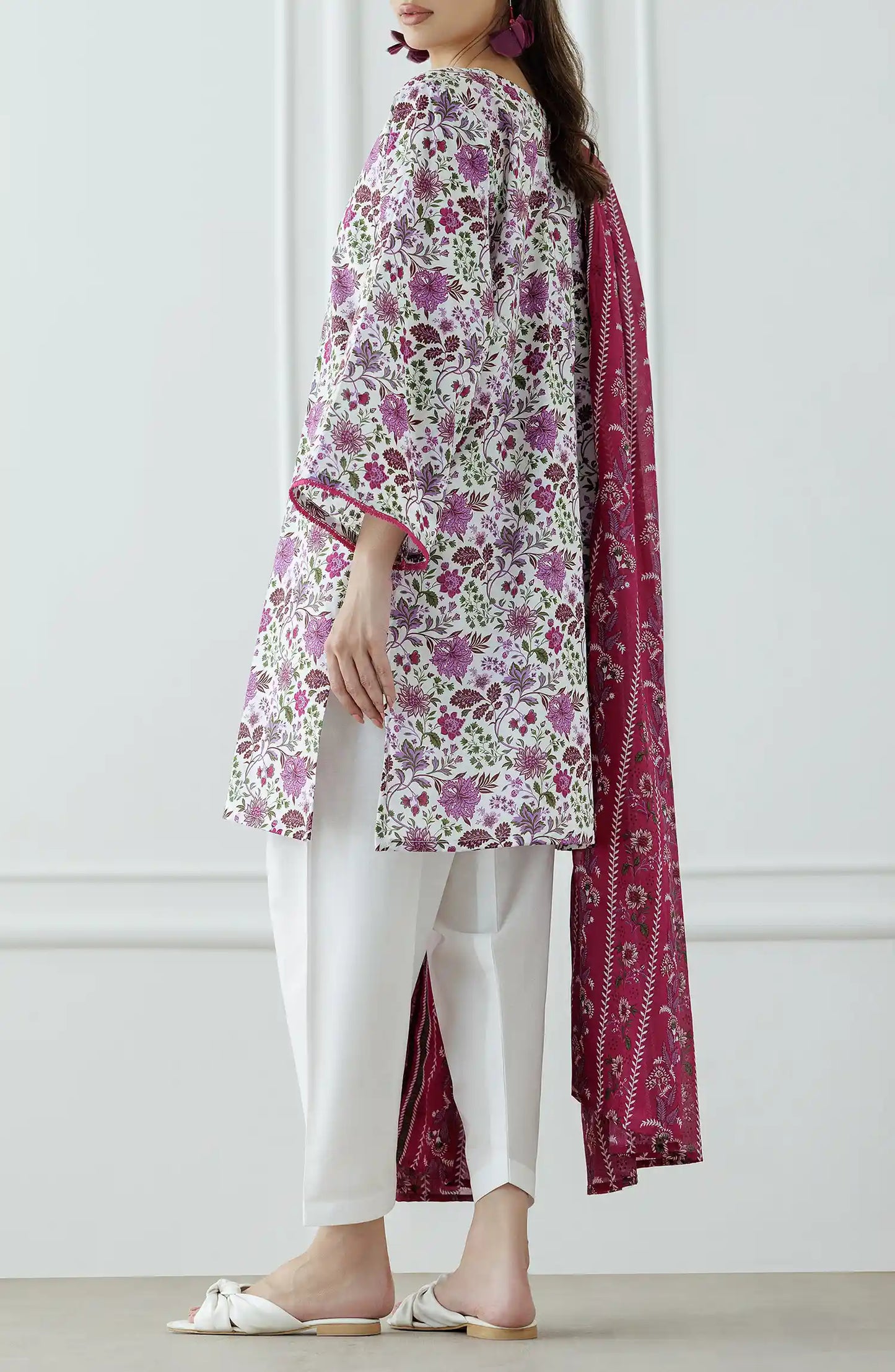 Woman wearing a floral kurta with white pants and a pink dupatta with plain shalwar trouser. Stitched Printed Lawn Shirt Dupatta & Pant - 3 Piece Suits - OTL-25-099