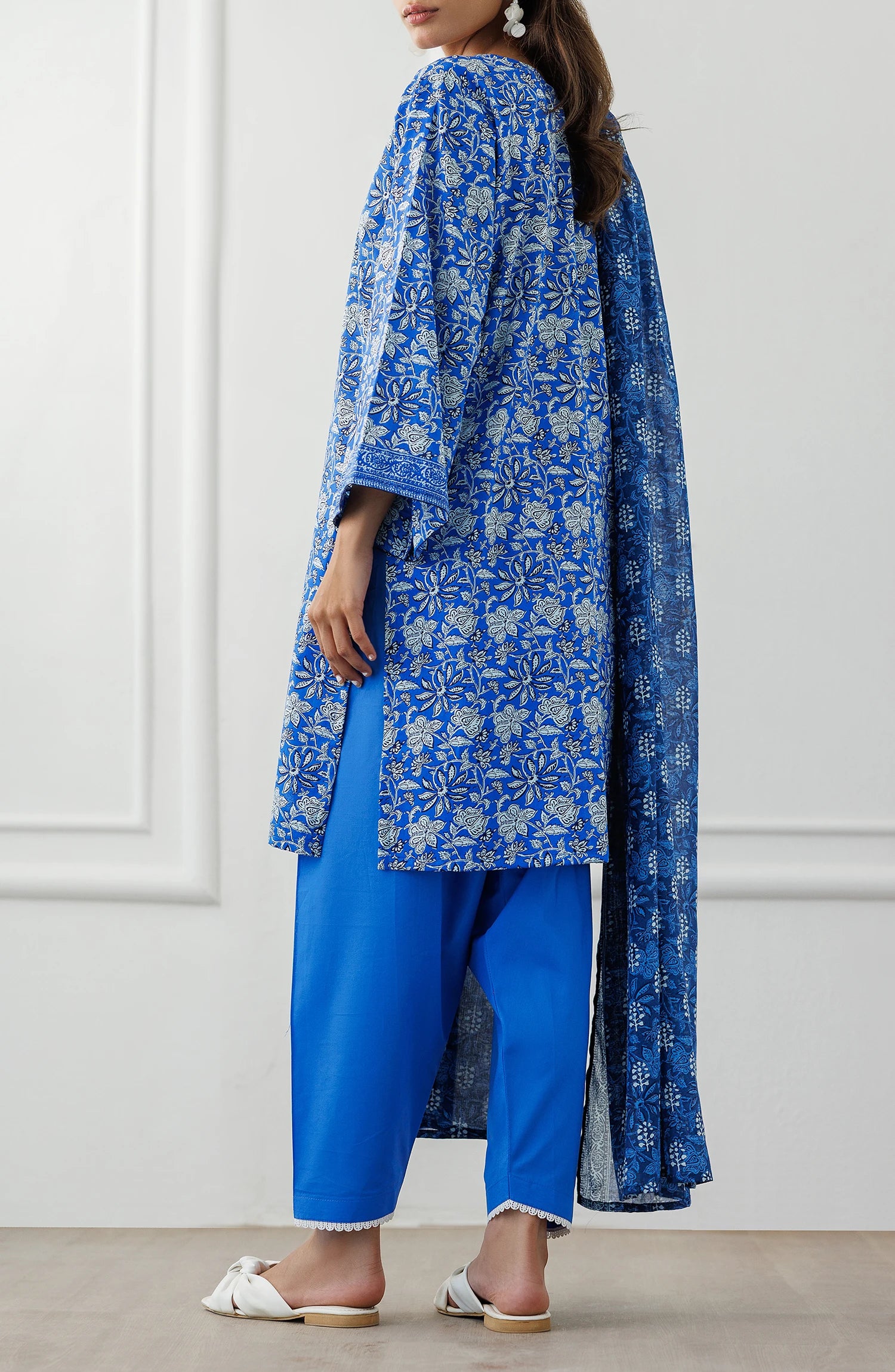 Woman wearing a blue floral kurta with matching pants and dupatta against a dyed shalwar. Unstitched Printed Lawn Shirt Dupatta & Pant - 3 Piece Suits - OTL-25-100