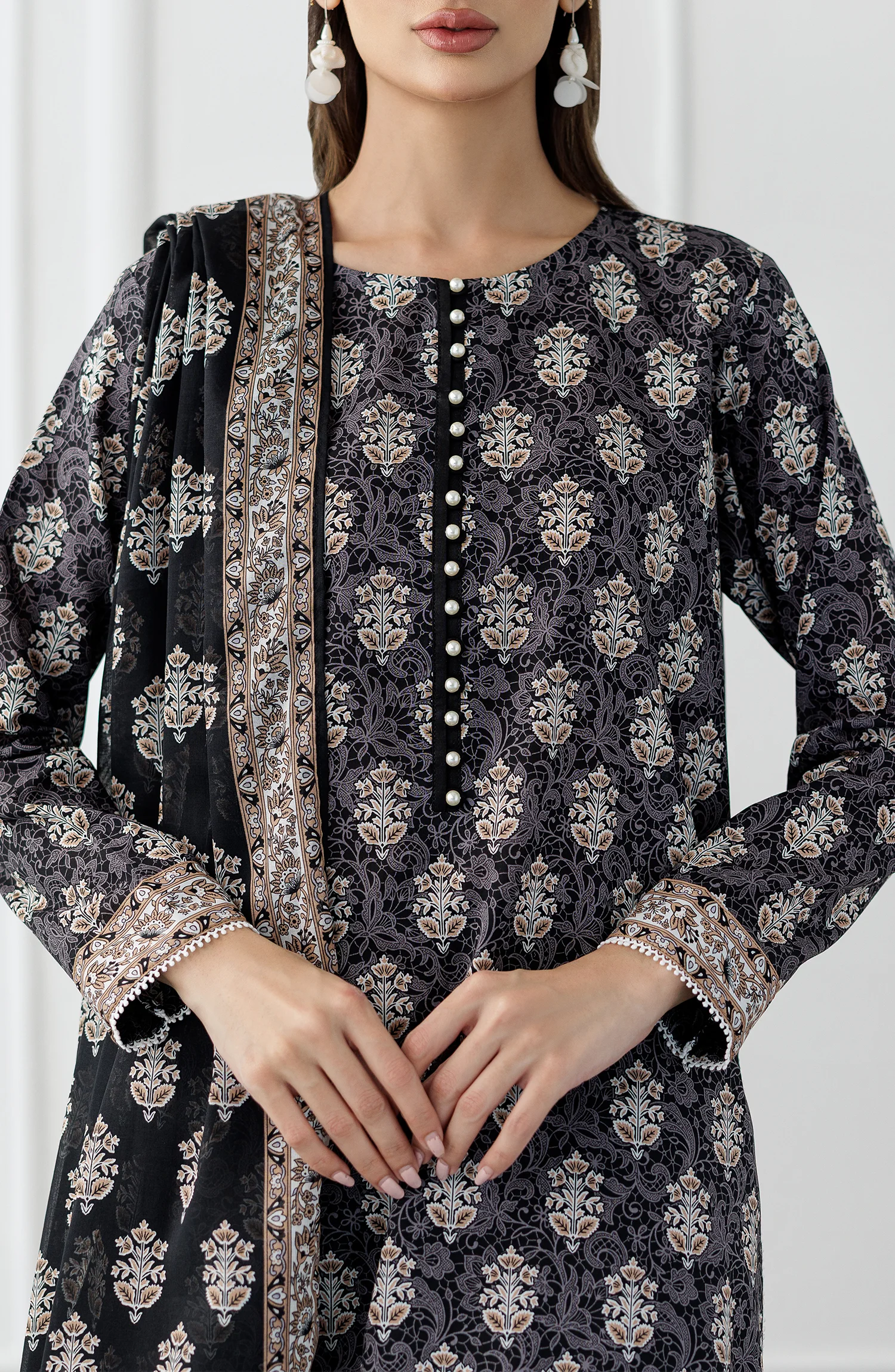 Woman wearing a black and white patterned kurta with a printed dupatta and against a dyed trouser. Stitched Printed Lawn Shirt Dupatta & Pant - 3 Piece Suits - OTL-25-105